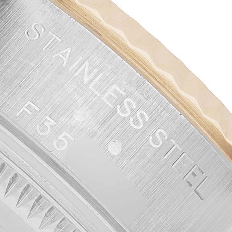 The image shows a close-up of the side of a Rolex Datejust 79173 Women's Stainless Steel White Dial watch highlighting the "STAINLESS STEEL" engraving.