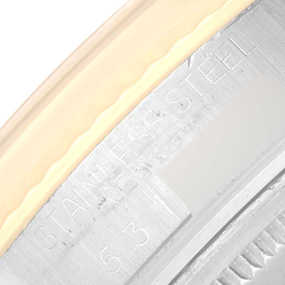 The image shows a close-up of the bezel and part of the case back of a Rolex Vintage Collection 16013 Men's Steel and Gold (two tone) White Dial 16013 Men's Steel and Gold (two tone) White Dial model, focusing on the "Stainless Steel" engraving.