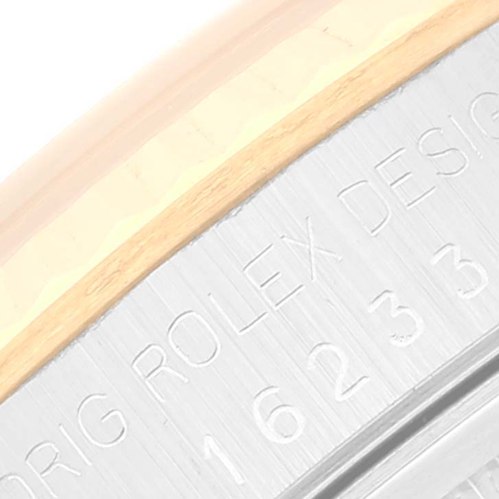 The image shows a close-up of the side of a Rolex Datejust 16233 Men's Steel and Gold (two tone) White Dial 16233 Men's Steel and Gold (two tone) White Dial watch, highlighting part of the case and the engraved model number.