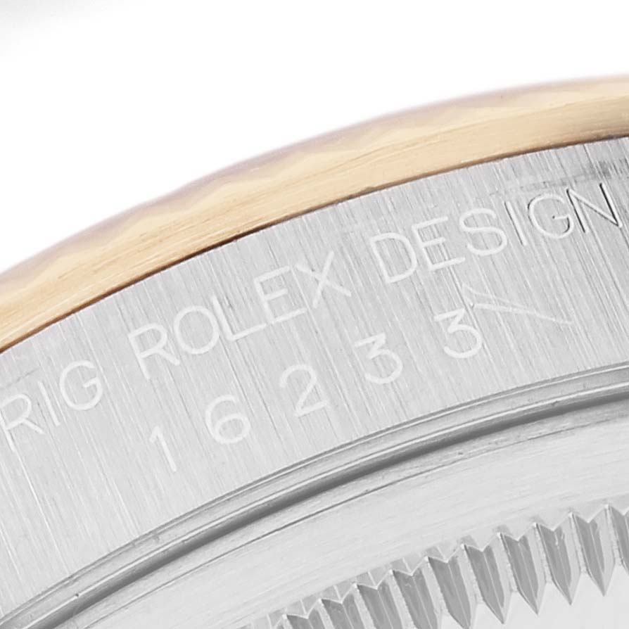 The image shows a close-up of the engraved bezel and lugs of a Rolex Datejust 16233 Men's Steel and Gold (two tone) White Dial 16233 Men's Steel and Gold (two tone) White Dial watch.