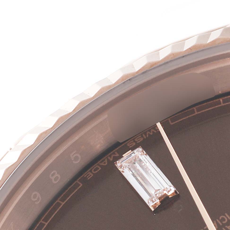 The image shows a close-up of the bezel and dial, revealing some detailing on the Rolex President 228235 Men's Rose Gold Brown Dial 228235 Men's Rose Gold Brown Dial watch.