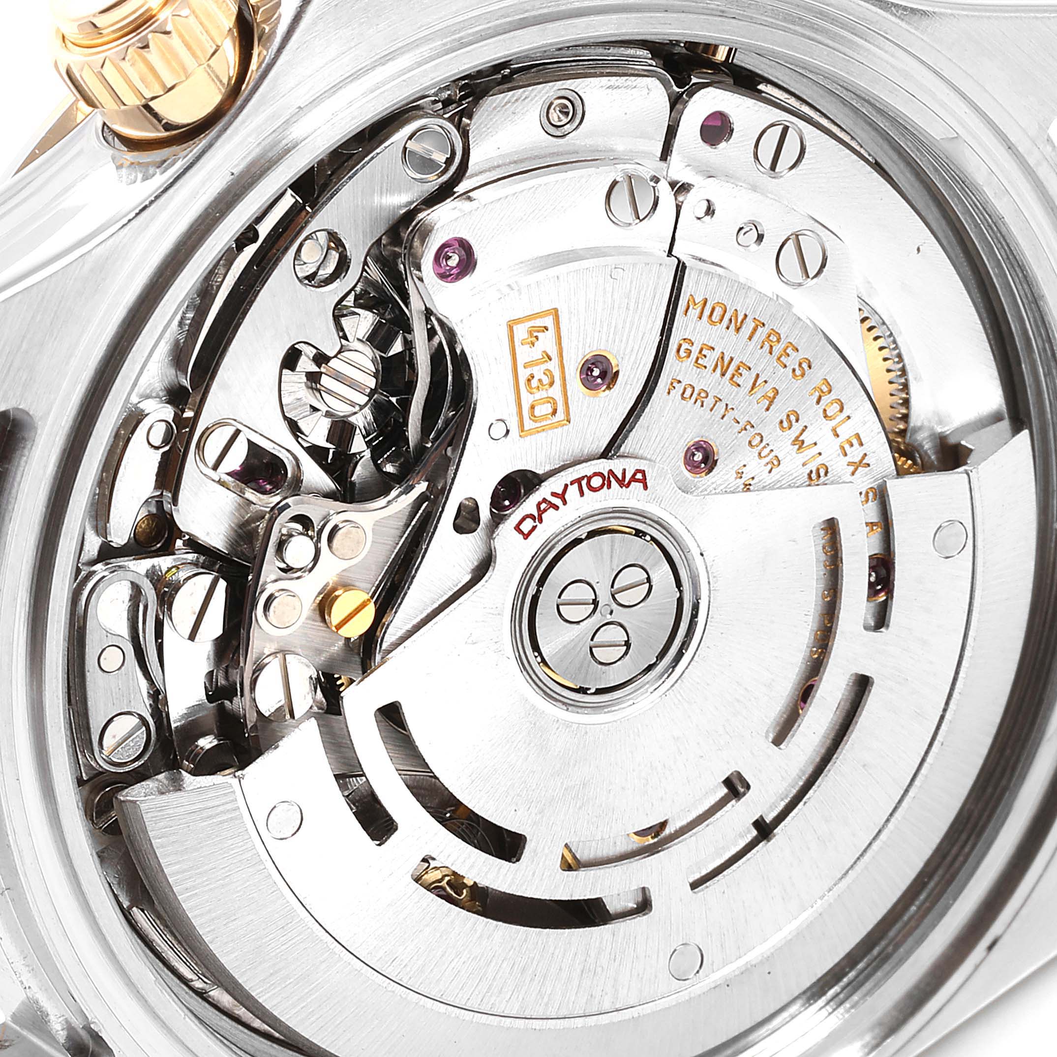 The image shows the inner mechanical movement of a Rolex Daytona 116523 Men
s Steel and Gold (two tone) Black Dial 116523 Men
s Steel and Gold (two tone) Black Dial watch, highlighting gears and inscriptions.