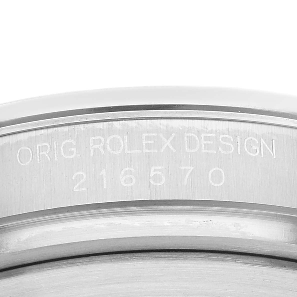 This image shows a close-up of the case back of a Rolex Explorer 216570 Men's Stainless Steel Black Dial 216570 Men's Stainless Steel Black Dial, displaying the engraving "ORIG. ROLEX DESIGN" with model number 216570.