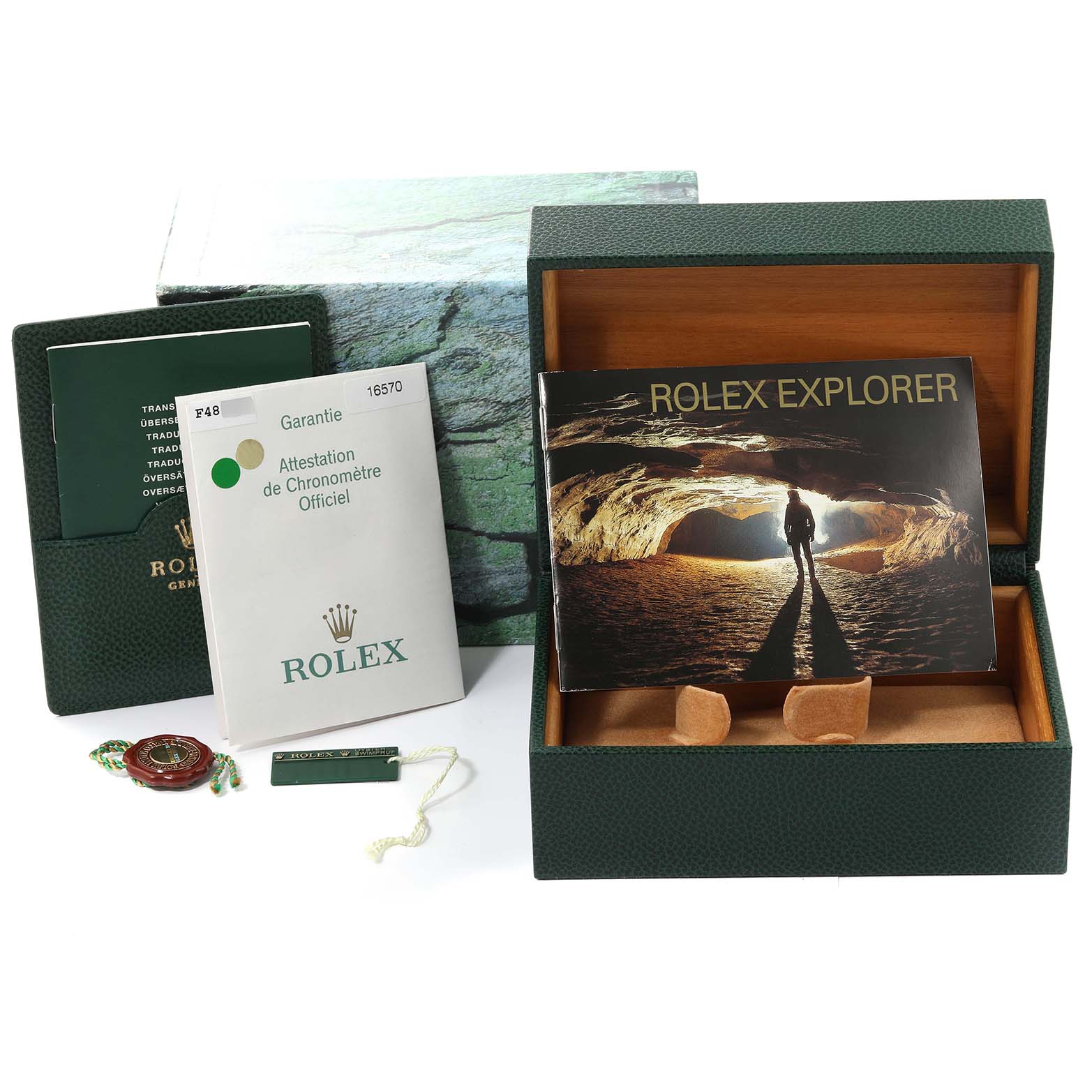 The image shows a Rolex Explorer 16570 Men
s Stainless Steel Black Dial 16570 Men
s Stainless Steel Black Dial watch box, manuals, warranty card, tag, and booklet from a frontal angle.
