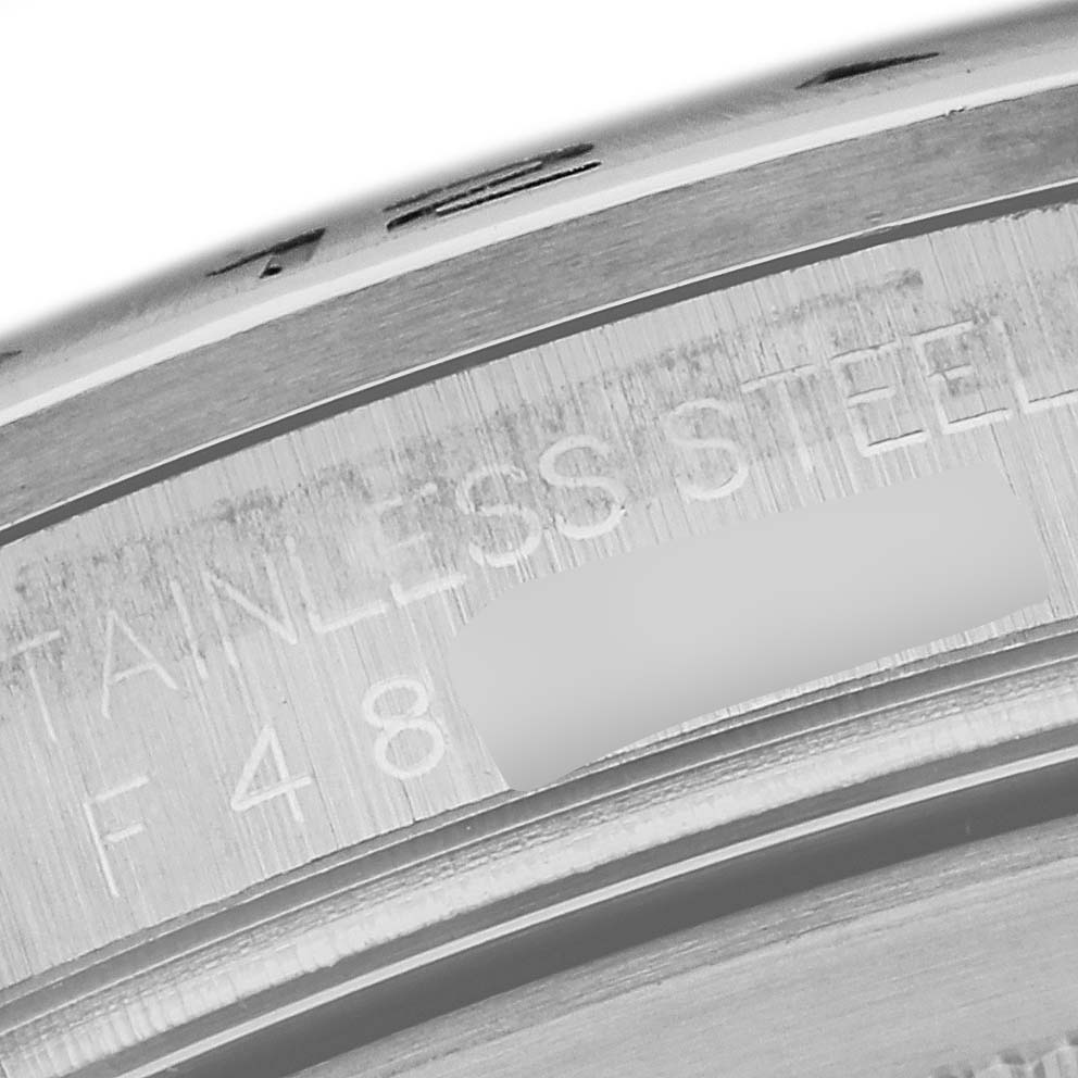 This close-up image shows the engraved bezel of a Rolex Explorer 16570 Men
s Stainless Steel Black Dial 16570 Men
s Stainless Steel Black Dial watch, specifically highlighting the "STAINLESS STEEL" inscription.