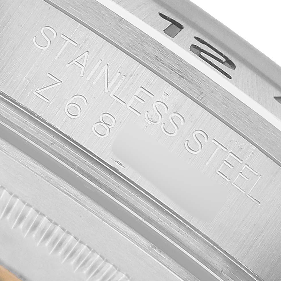 The image shows a close-up of the case's inner engraving on a Rolex Explorer 16570 Men's Stainless Steel Black Dial, highlighting "STAINLESS STEEL."