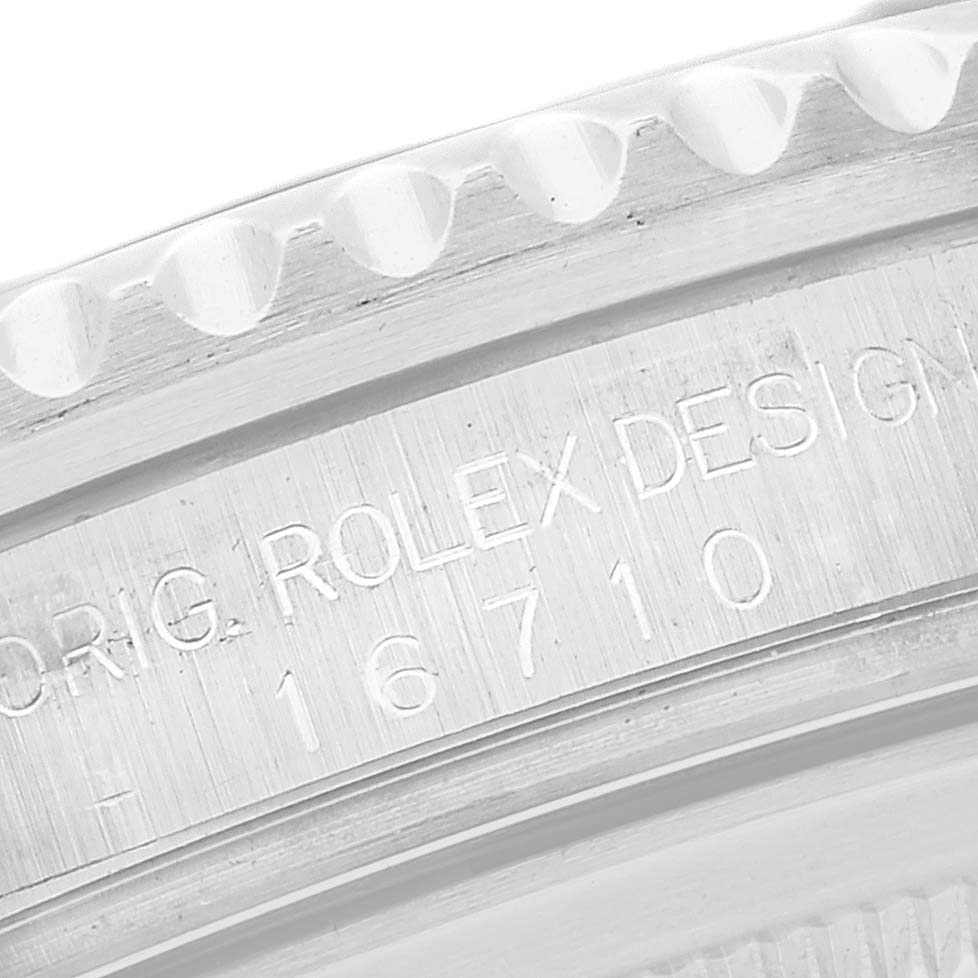 The image shows a close-up of the Rolex GMT-Master 16710 Men
s Stainless Steel Black Dial 16710 Men
s Stainless Steel Black Dial model
s case side, featuring the model number engraving.