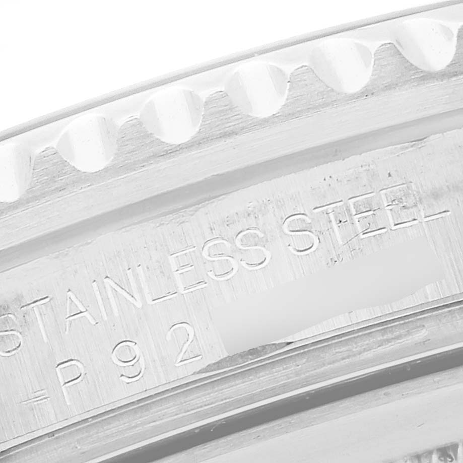 This image shows a close-up of the side of the Rolex GMT-Master 16710 Men
s Stainless Steel Black Dial 16710 Men
s Stainless Steel Black Dial watch
s stainless steel case with engraving details.