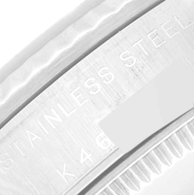 This image shows a close-up angle of the bezel and case side of a Mid-Size Rolex watch, highlighting the stainless steel engraving.