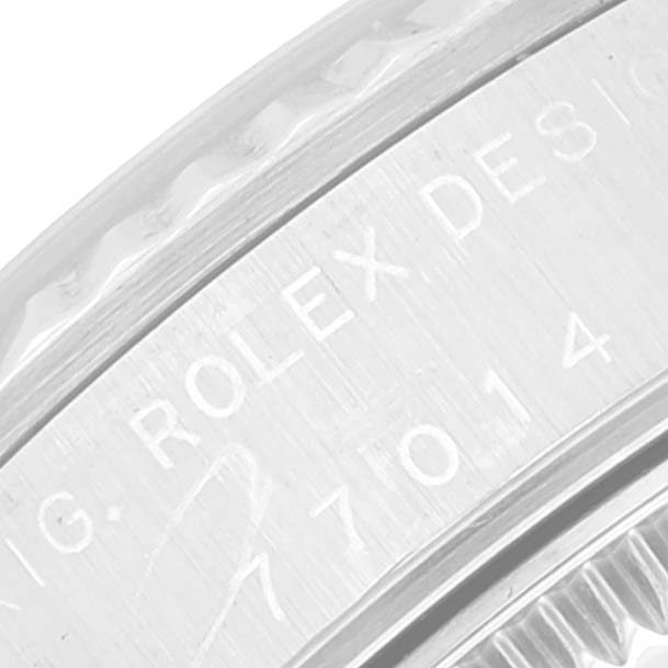 The image shows a close-up of the engravings on the bezel of a Rolex Mid-Size 77014 Women
s Stainless Steel Silver Dial 77014 Women
s Stainless Steel Silver Dial watch model.