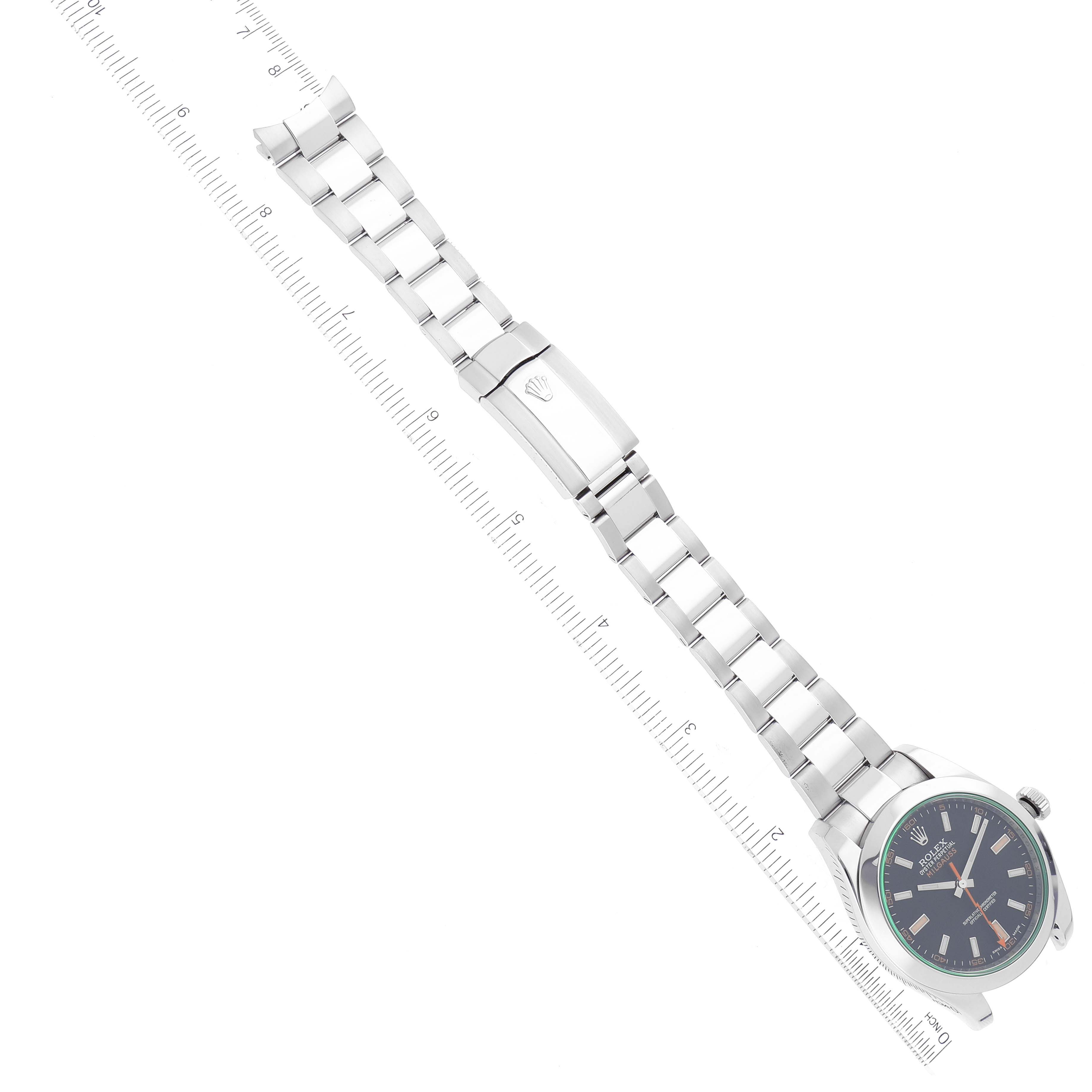 The image shows a Rolex Milgauss 116400 Men's Stainless Steel Black Dial 116400 Men's Stainless Steel Black Dial watch with its full bracelet extended and a ruler for scale, viewed from a top-down angle.