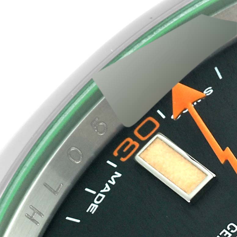 The image shows a close-up of the Rolex Milgauss 116400 Men's Stainless Steel Black Dial 116400 Men's Stainless Steel Black Dial watch dial, focusing on the 30-minute marker and the orange second hand.