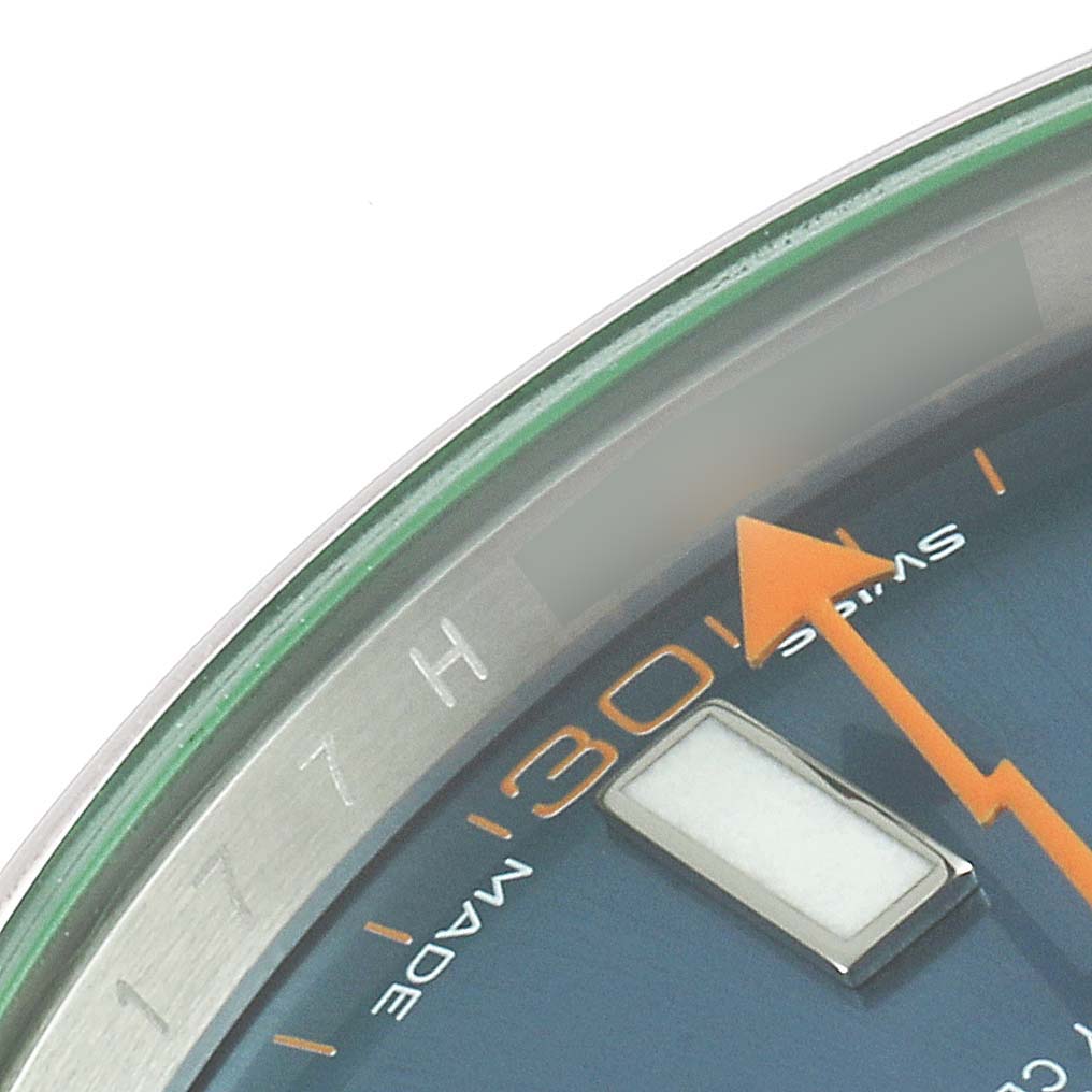 The image shows a close-up of the dial and bezel, focusing on the orange lightning bolt second hand and part of the hour markers of a Rolex Milgauss 116400GV Men
s Stainless Steel Blue Dial 116400GV Men
s Stainless Steel Blue Dial watch.