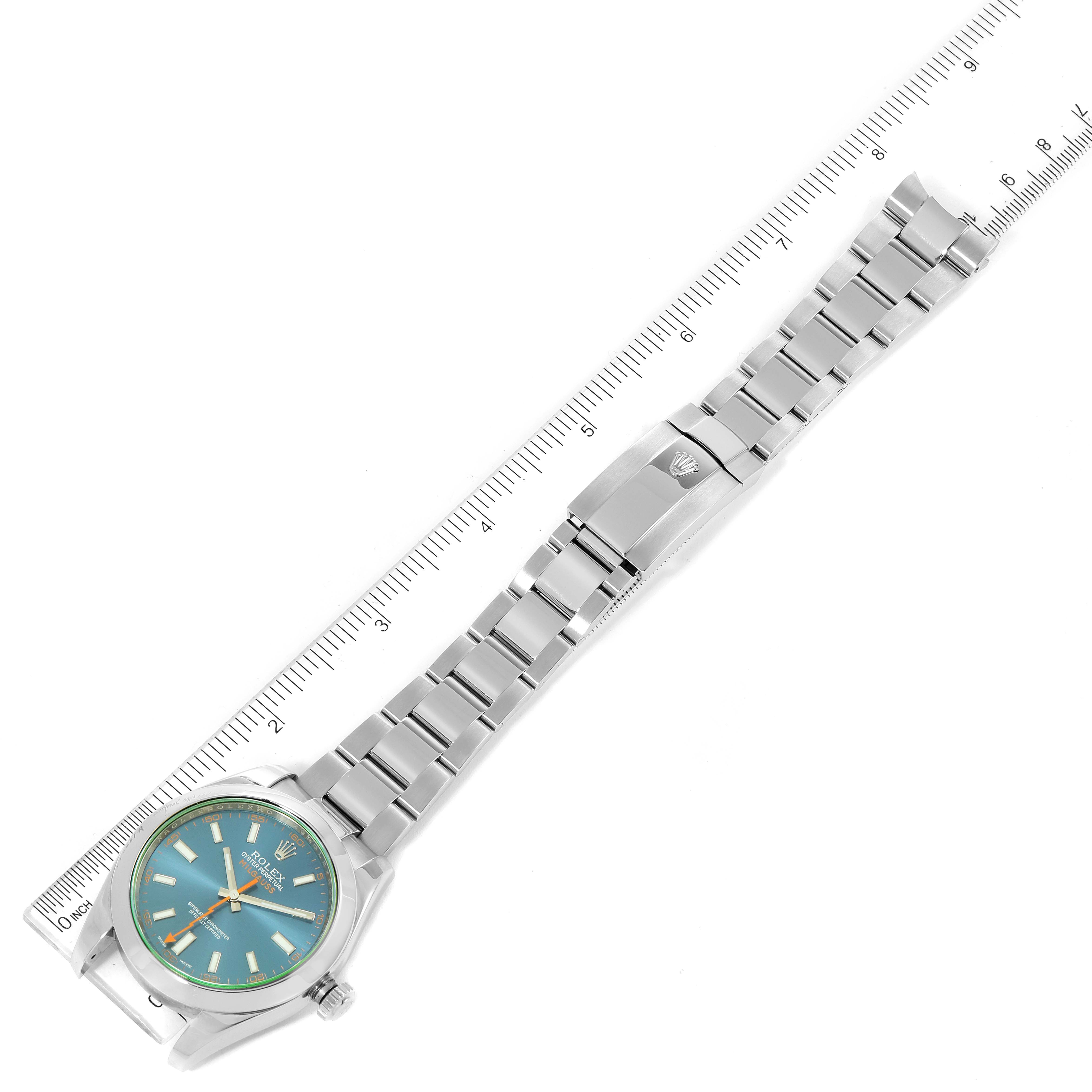 The image shows a Rolex Milgauss 116400GV Men
s Stainless Steel Blue Dial 116400GV Men
s Stainless Steel Blue Dial watch laid flat with a ruler for scale, displaying the watch face, bracelet, and clasp.