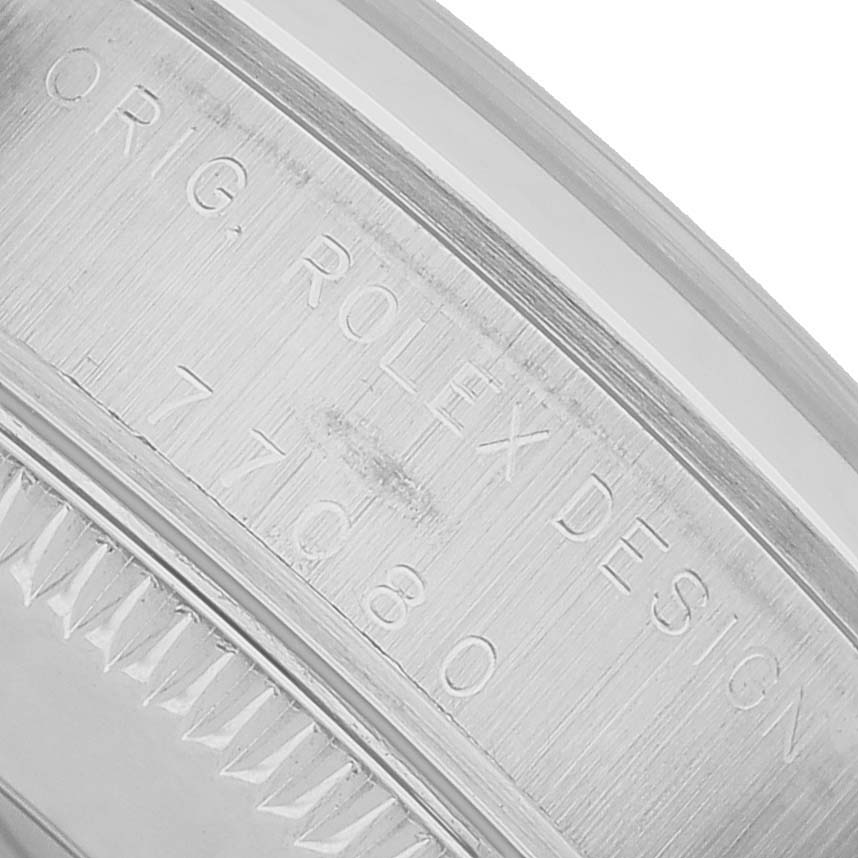 The image shows a close-up of the bezel and case side engraving on a Rolex Oyster Perpetual 77200 Women's Stainless Steel Pink Dial.
