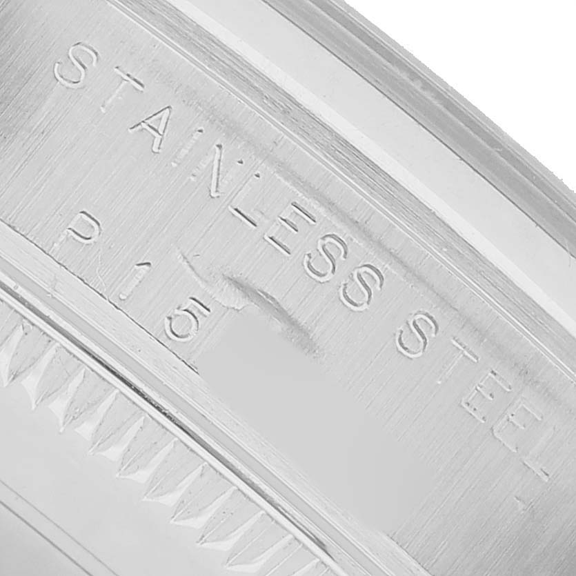 The image shows a close-up of the side engraving on a Rolex Oyster Perpetual 77200 Women's Stainless Steel Pink Dial watch, focusing on the "Stainless Steel" inscription.