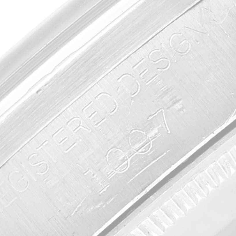 The image shows a close-up of the engraved casing for a Vintage Collection model by Rolex.