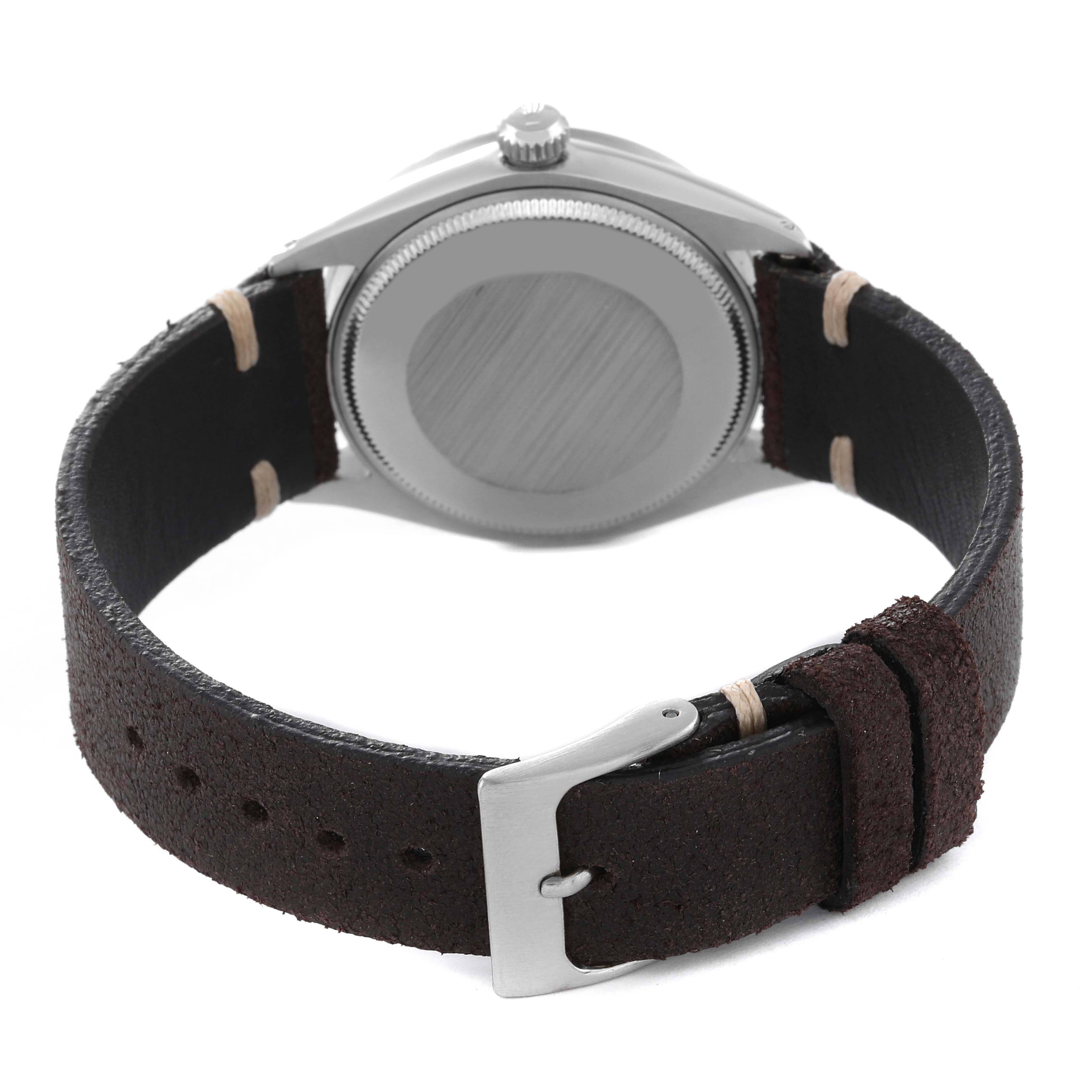 This image shows the back of a Rolex Vintage Collection 1007 Men's Stainless Steel Silver Dial 1007 Men's Stainless Steel Silver Dial watch, featuring its case back, leather strap, and buckle.