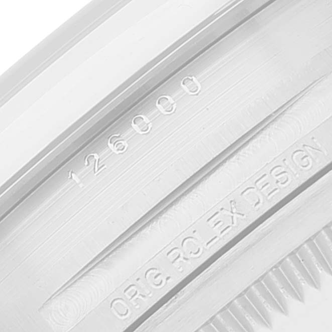 This close-up image shows the engraving on the inner bezel of a Rolex Oyster Perpetual 126000 Men's Stainless Steel Silver Dial 126000 Men's Stainless Steel Silver Dial model.