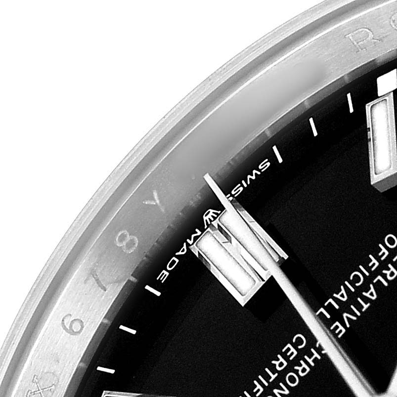 The image shows a partial close-up of the Rolex Oyster Perpetual 126000 Men's Stainless Steel Black Dial watch face, including the hands, markers, and the "Swiss Made" text.