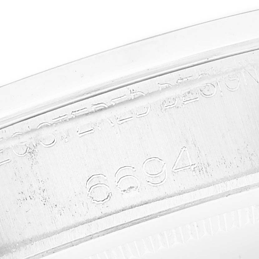 The image shows an engraved serial number on the side of a Rolex Vintage Collection 6694 Men's Stainless Steel Silver Dial 6694 Men's Stainless Steel Silver Dial model.