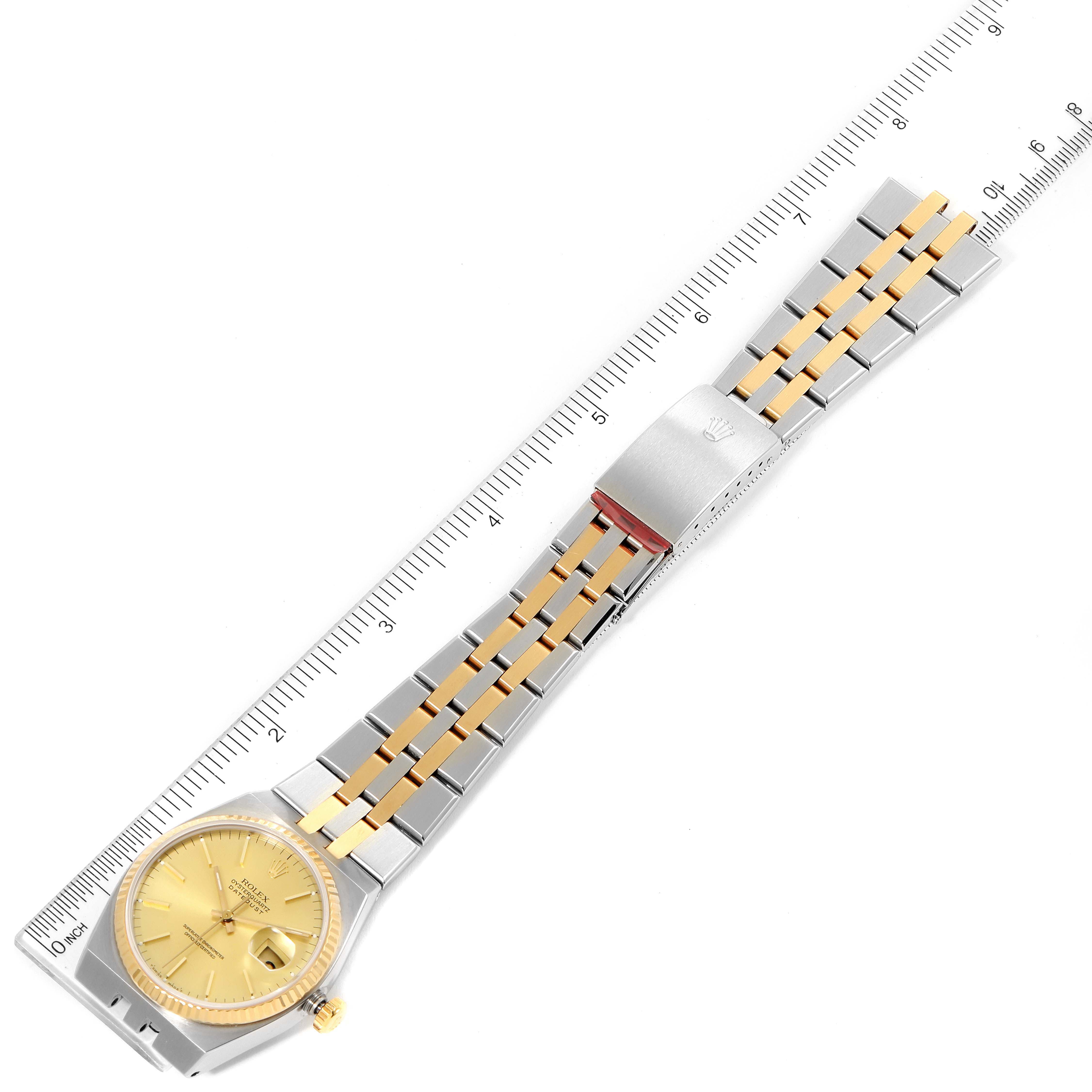 The image shows a top view of a Rolex Oysterquartz 17013 Men's Steel and Gold (two tone) Champagne Dial 17013 Men's Steel and Gold (two tone) Champagne Dial watch, highlighting the bracelet and dial, placed next to a measuring ruler.