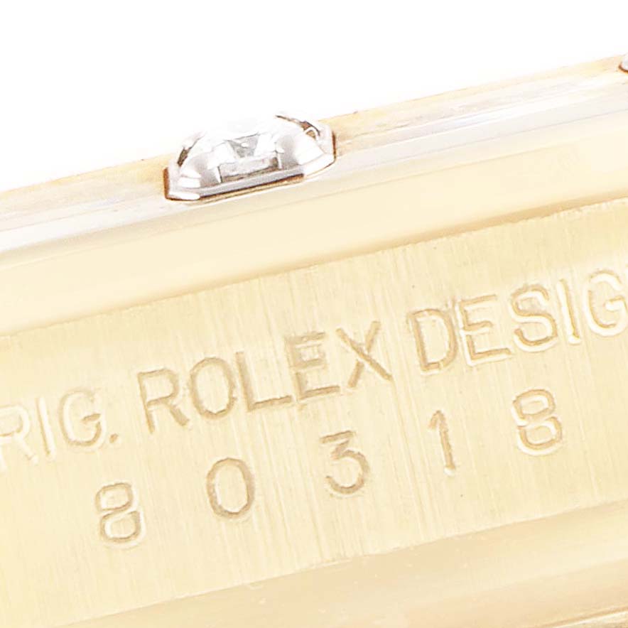The image shows a close-up view of the side case of a Rolex Pearlmaster 80318 Women's Yellow Gold Mother of Pearl Dial 80318 Women's Yellow Gold Mother of Pearl Dial watch, highlighting the engraving and a side crystal.