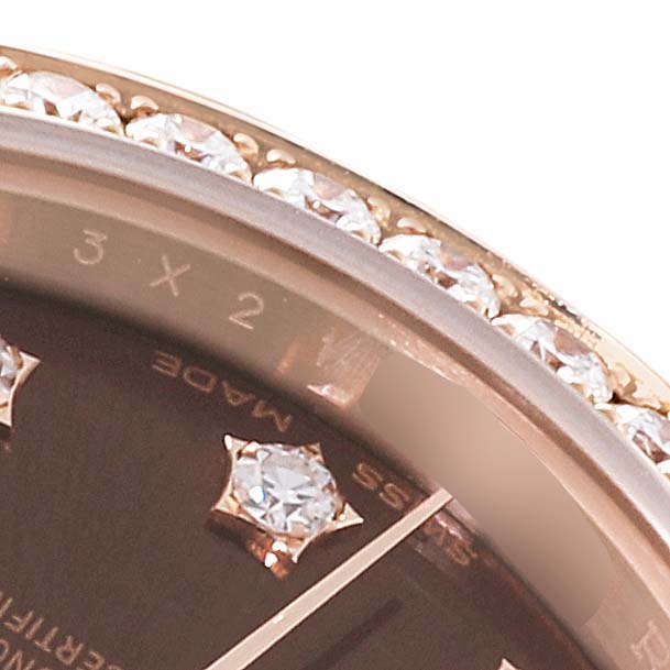 This close-up shot of the Rolex President 279135 Women's Rose Gold Brown Dial 279135 Women's Rose Gold Brown Dial model showcases the diamond-encrusted bezel and part of the dial with gem markers.