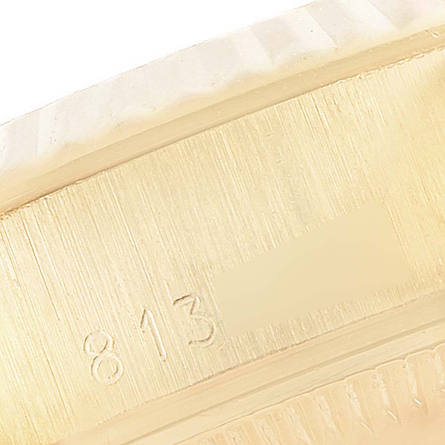 This close-up image shows the inner bezel and part of the serial number of a Rolex President 69178 Women
s Yellow Gold Champagne Dial 69178 Women
s Yellow Gold Champagne Dial model watch.