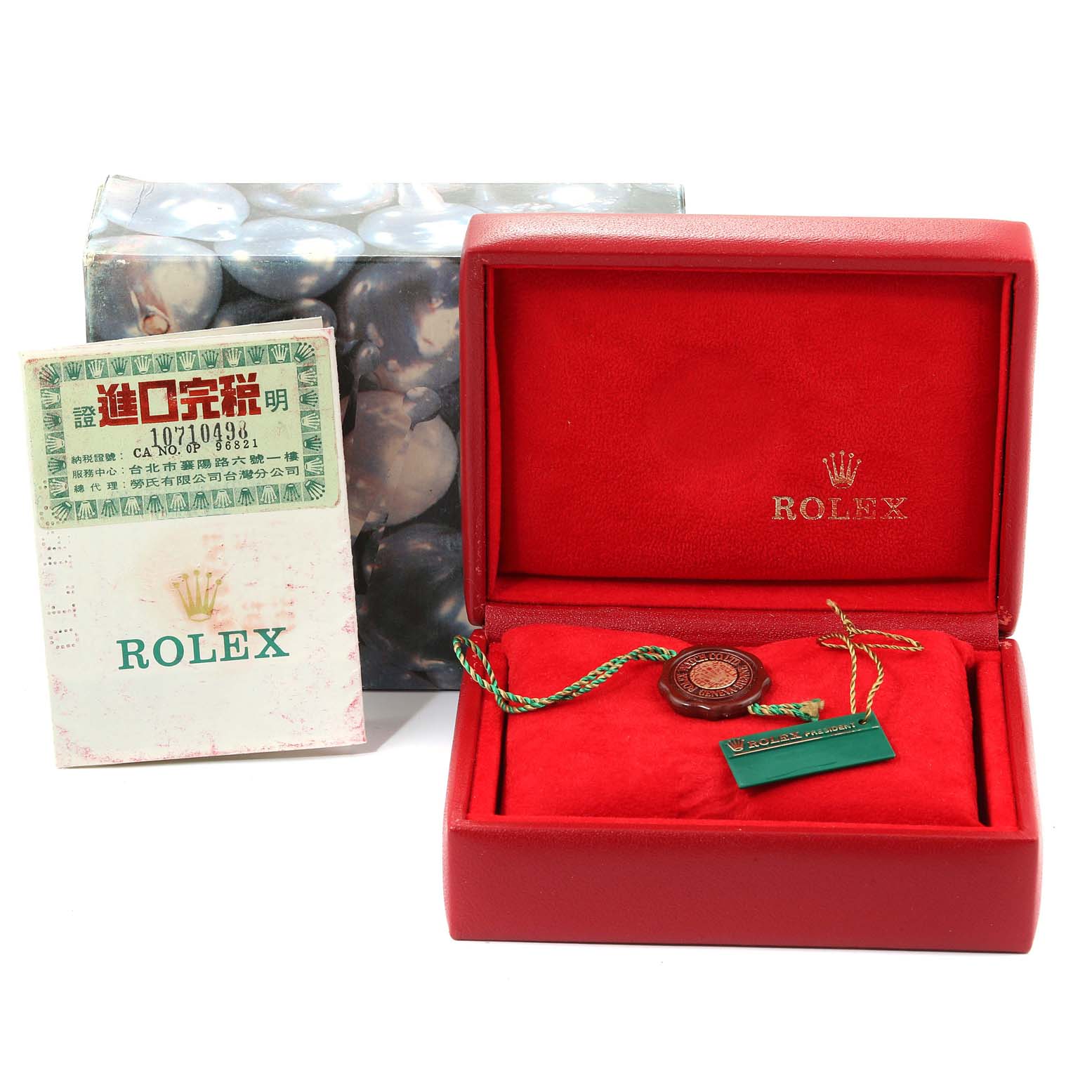 This image shows the packaging and accessories for a Rolex President 69258 Women
s Yellow Gold Champagne Dial 69258 Women
s Yellow Gold Champagne Dial model, including the box, tag, and booklet, but not the watch itself.