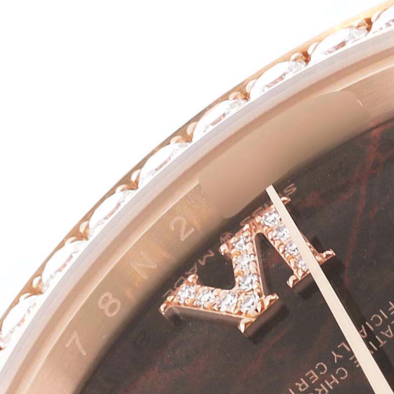 This close-up image of the Rolex President 128345RBR Men's Rose Gold Brown Dial 128345RBR Men's Rose Gold Brown Dial model shows the bezel, part of the dial, and the hour markers.