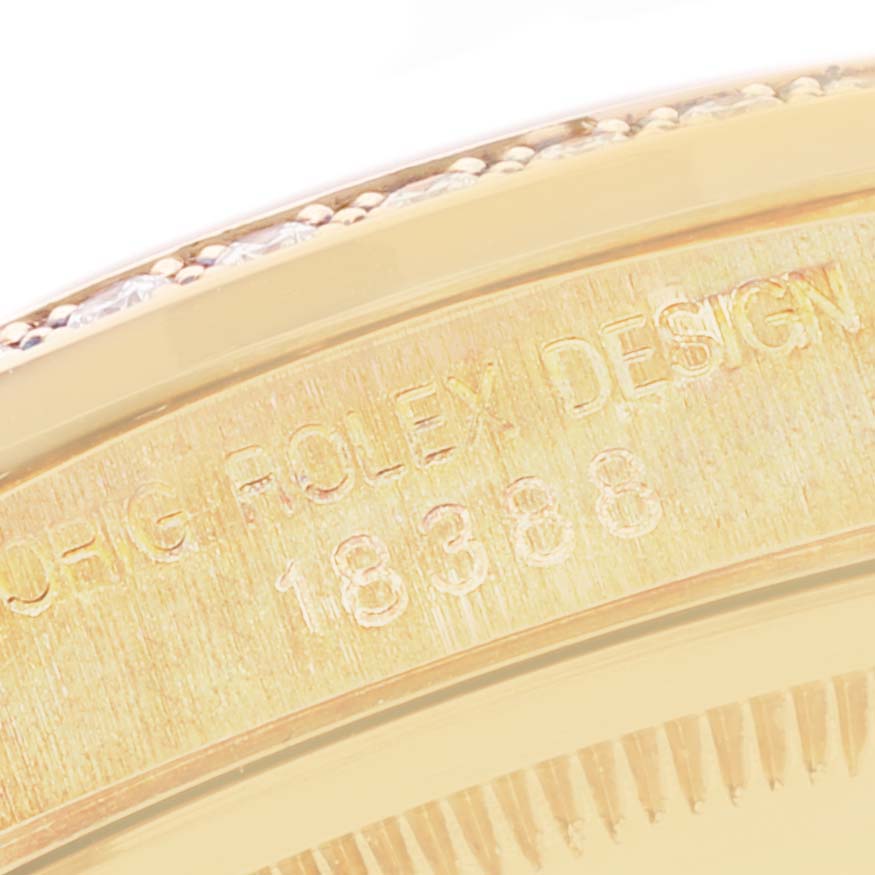 The image shows an angled close-up of the side of a Rolex President 18338 Men
s Yellow Gold Champagne Dial 18338 Men
s Yellow Gold Champagne Dial model watch, displaying part of the bezel and an engraved serial number.
