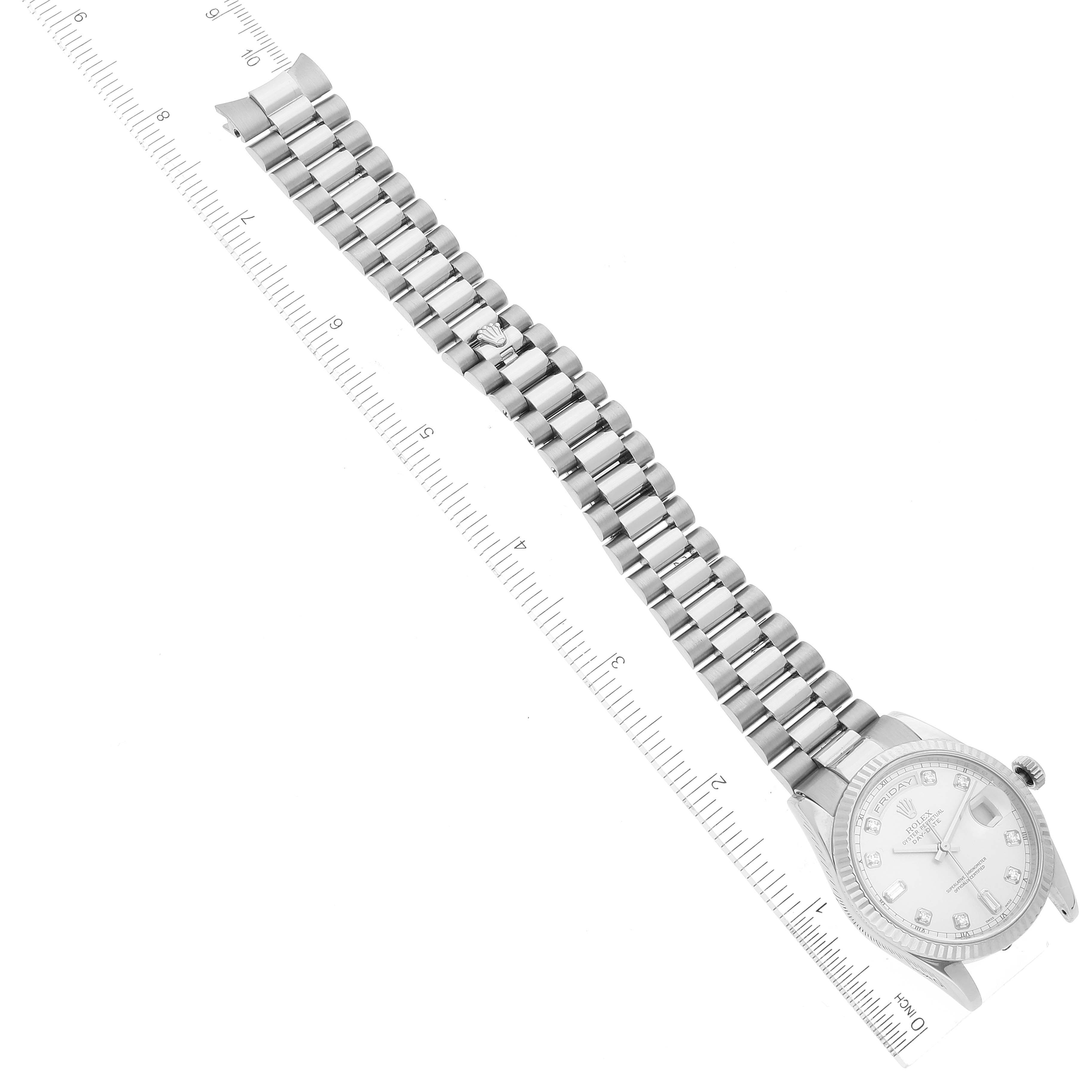 This image shows a top-down view of a Rolex President 118239 Men's White Gold Silver Dial 118239 Men's White Gold Silver Dial model watch, displaying the watch face, band, and part of a measuring ruler.