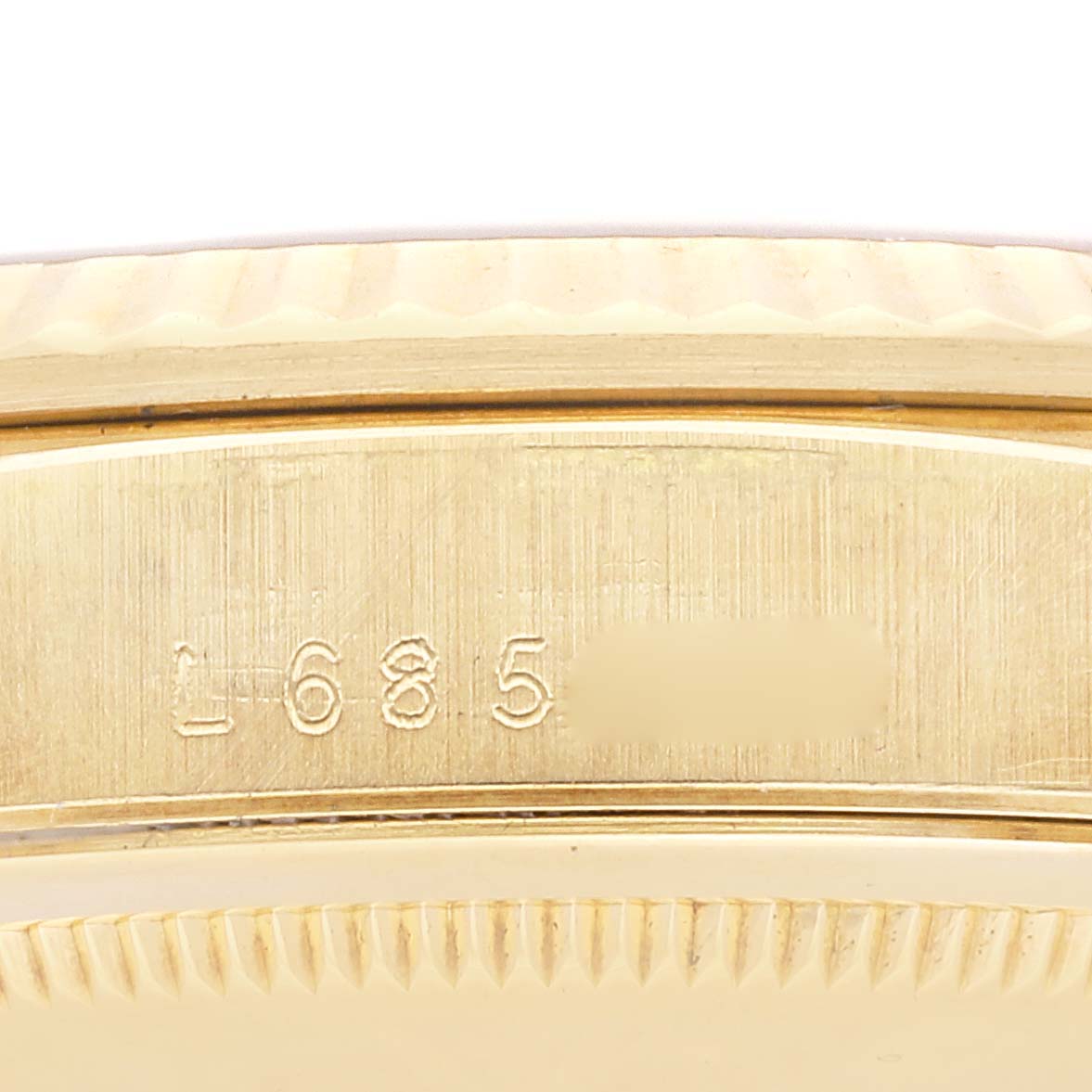 This image shows the side profile of the Rolex President 18238 Men's Yellow Gold Black Dial 18238 Men's Yellow Gold Black Dial model watch, focusing on the serial number engraved on the case.