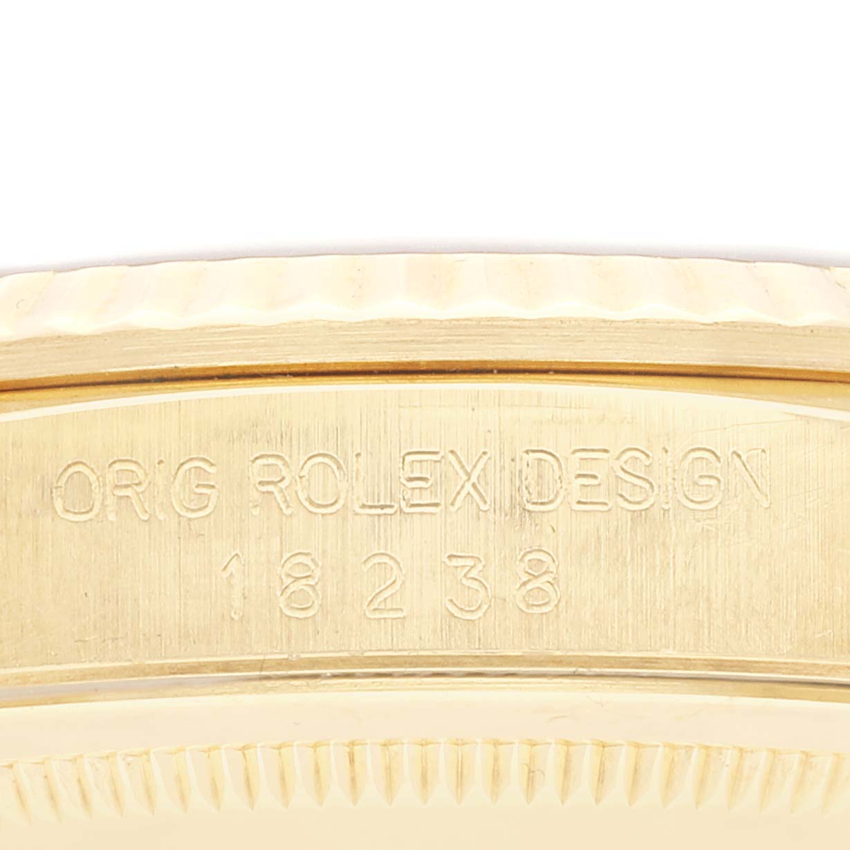 This image shows a close-up view of the side of the Rolex President 18238 Men's Yellow Gold Black Dial 18238 Men's Yellow Gold Black Dial model, highlighting its case engravings.
