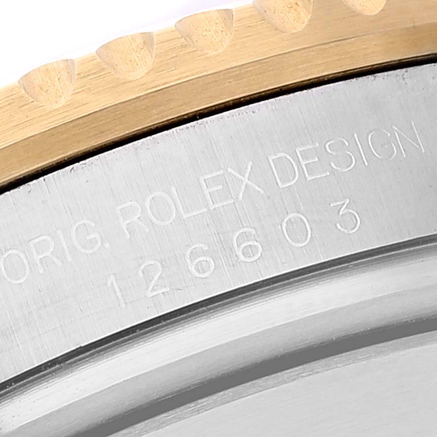 The image shows a close-up of the bezel and engraved serial number on the case of a Rolex Sea-Dweller 126603 Men's Steel and Gold (two tone) Black Dial 126603 Men's Steel and Gold (two tone) Black Dial watch, model 126603.
