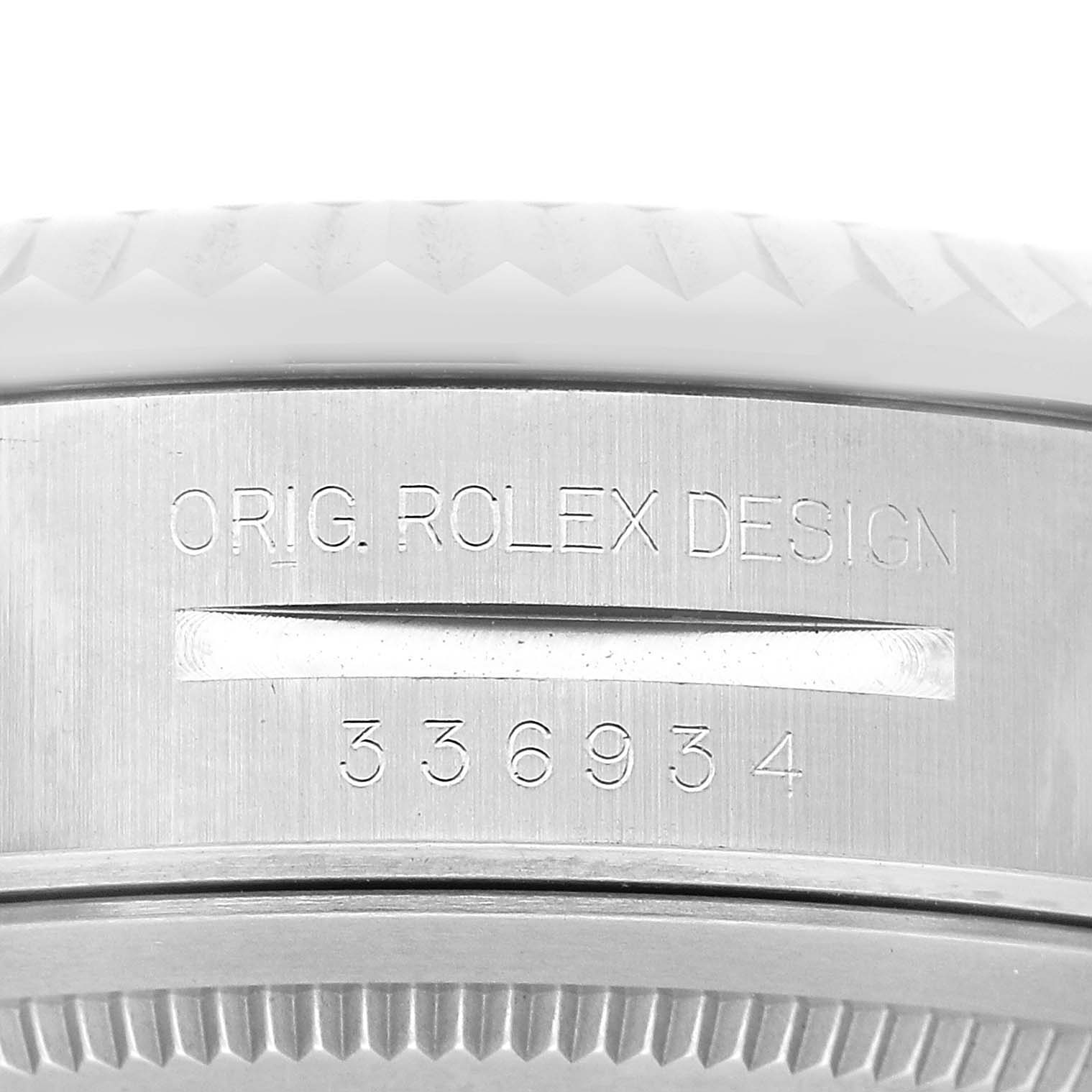 The image shows the side of a Rolex Sky-Dweller 336934 Men's Stainless Steel Blue Dial watch, highlighting the engraved design and serial number.