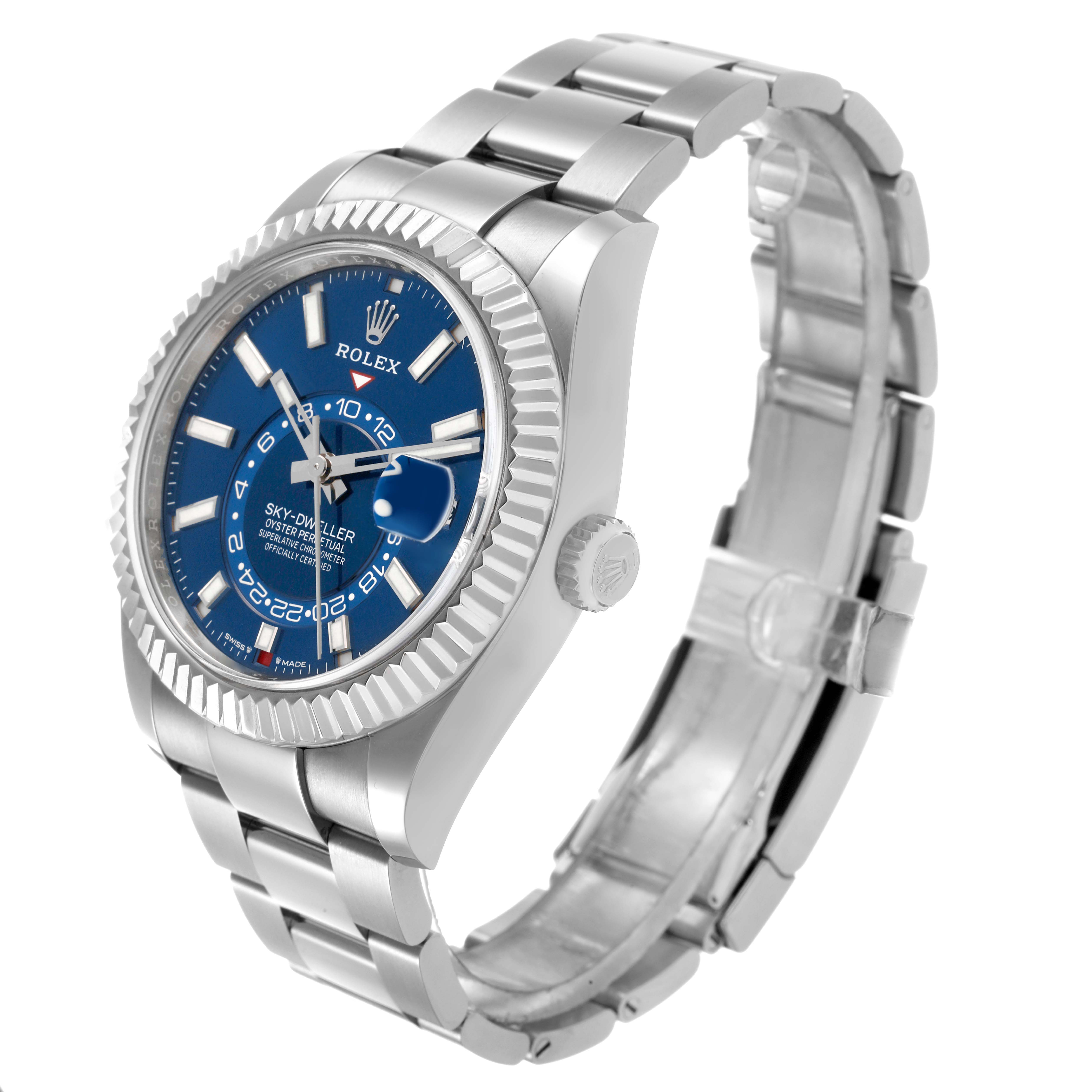 The Rolex Sky-Dweller 336934 Men's Stainless Steel Blue Dial watch is shown at a three-quarter angle, highlighting its blue dial, fluted bezel, and metal bracelet.