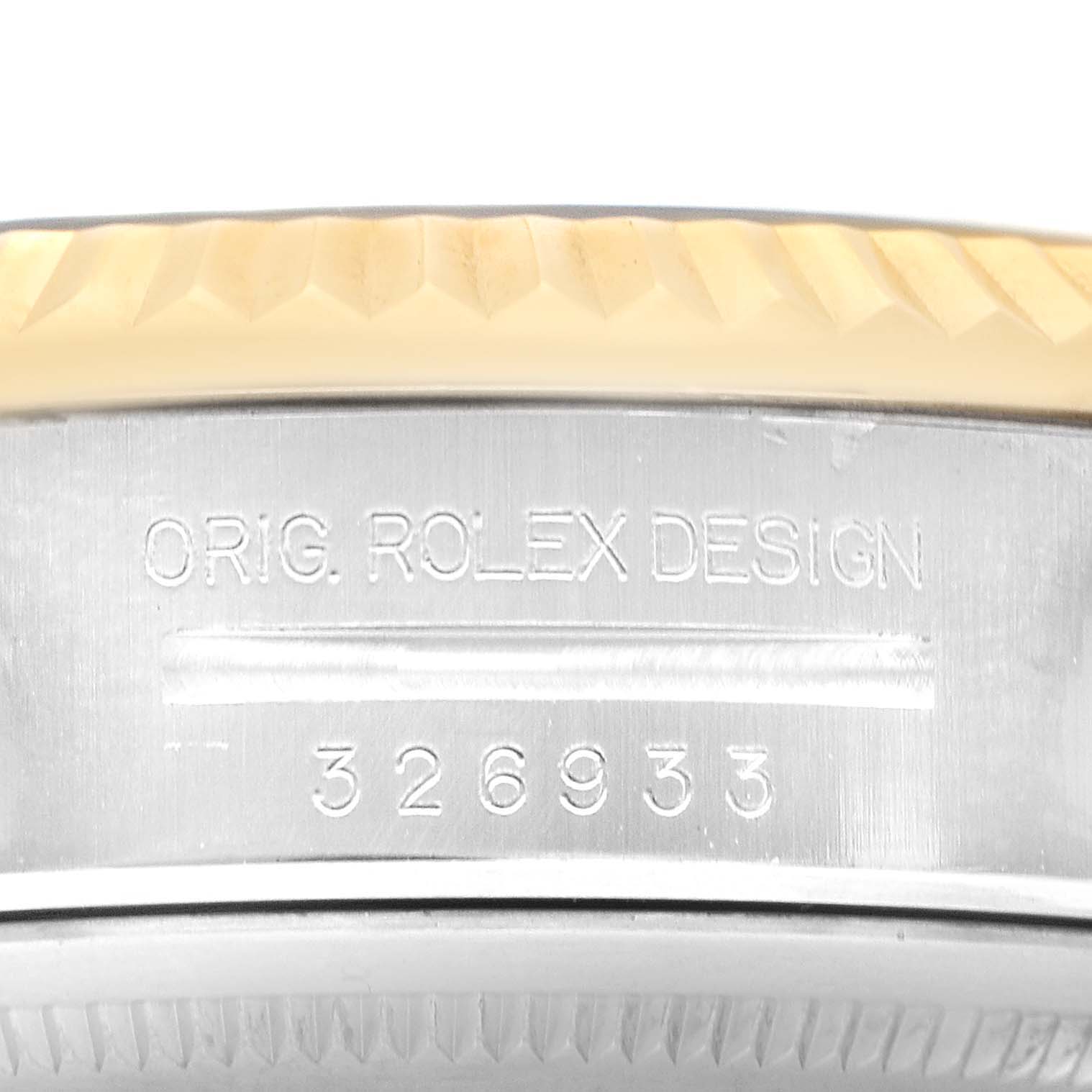 The image shows the side of a Rolex Sky-Dweller 326933 Men's Steel and Gold (two tone) Black Dial, displaying its serial number and design engraving.
