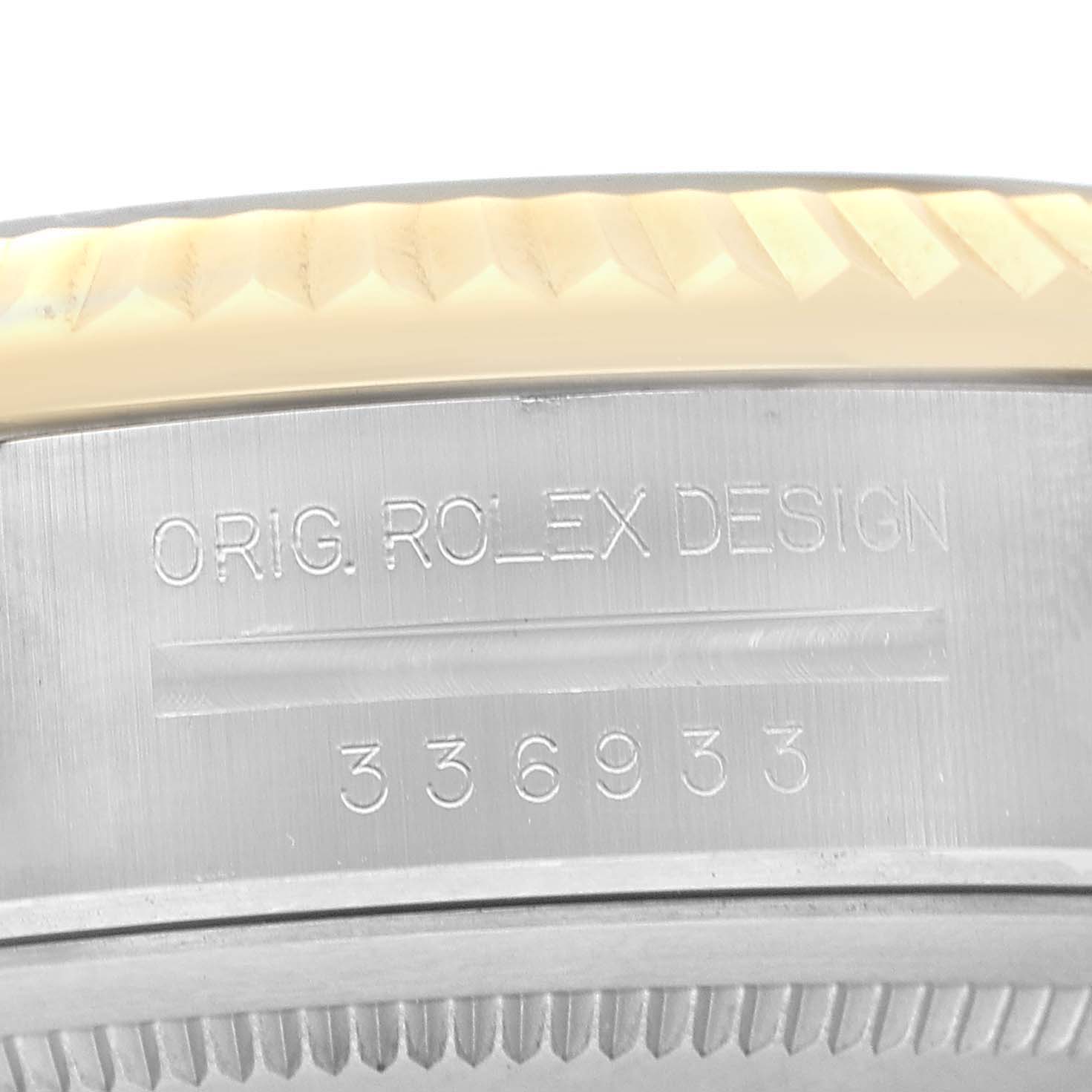 The image shows a close-up of a Rolex Sky-Dweller 336933 Men's Steel and Gold (two tone) Black Dial's engraved bezel edge, showcasing the serial number and "ORIG. ROLEX DESIGN."
