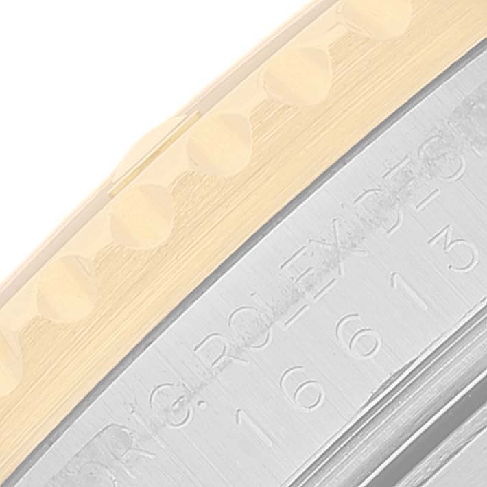 The image shows a close-up of the bezel and the side of a Rolex Submariner 16613 Men's Steel and Gold (two tone) Blue Dial 16613 Men's Steel and Gold (two tone) Blue Dial watch, featuring the engraved model number.