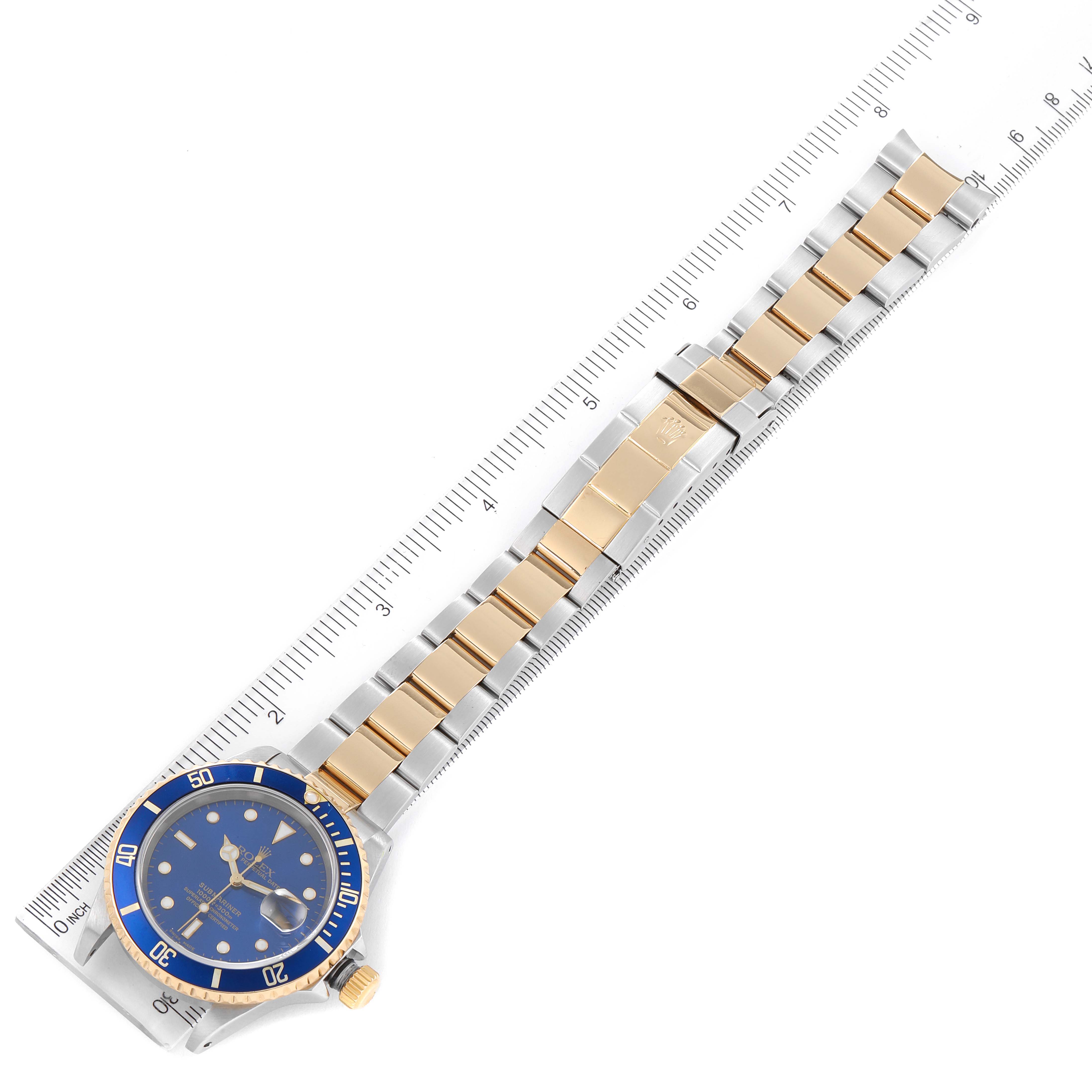 The Rolex Submariner 16613 Men's Steel and Gold (two tone) Blue Dial 16613 Men's Steel and Gold (two tone) Blue Dial watch is shown from an overhead angle, displaying the full bracelet, clasp, and the watch face.