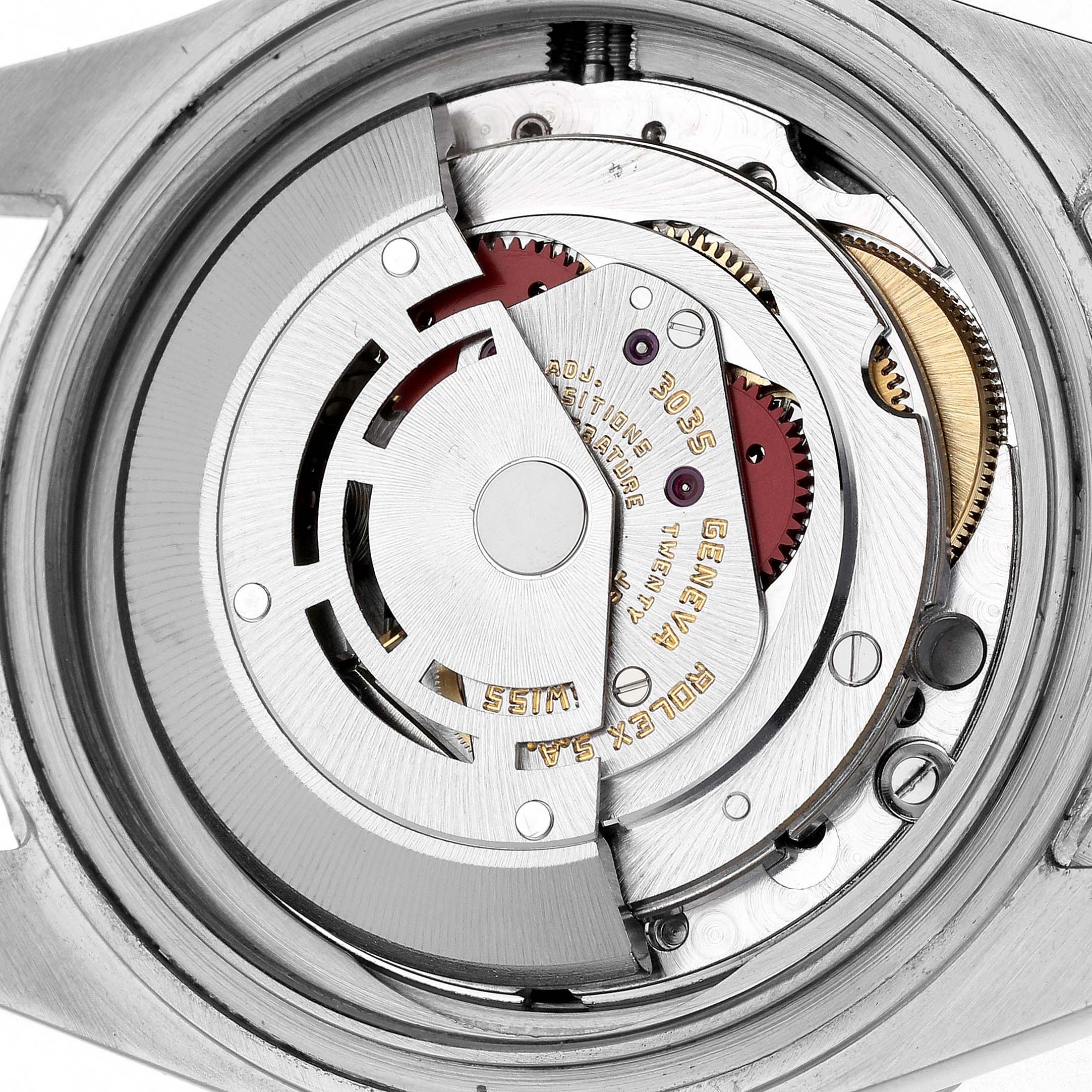 The image shows the movement of a Rolex Submariner 16800 Men's Stainless Steel Black Dial, highlighting the intricate gears and rotor from a top-down angle.