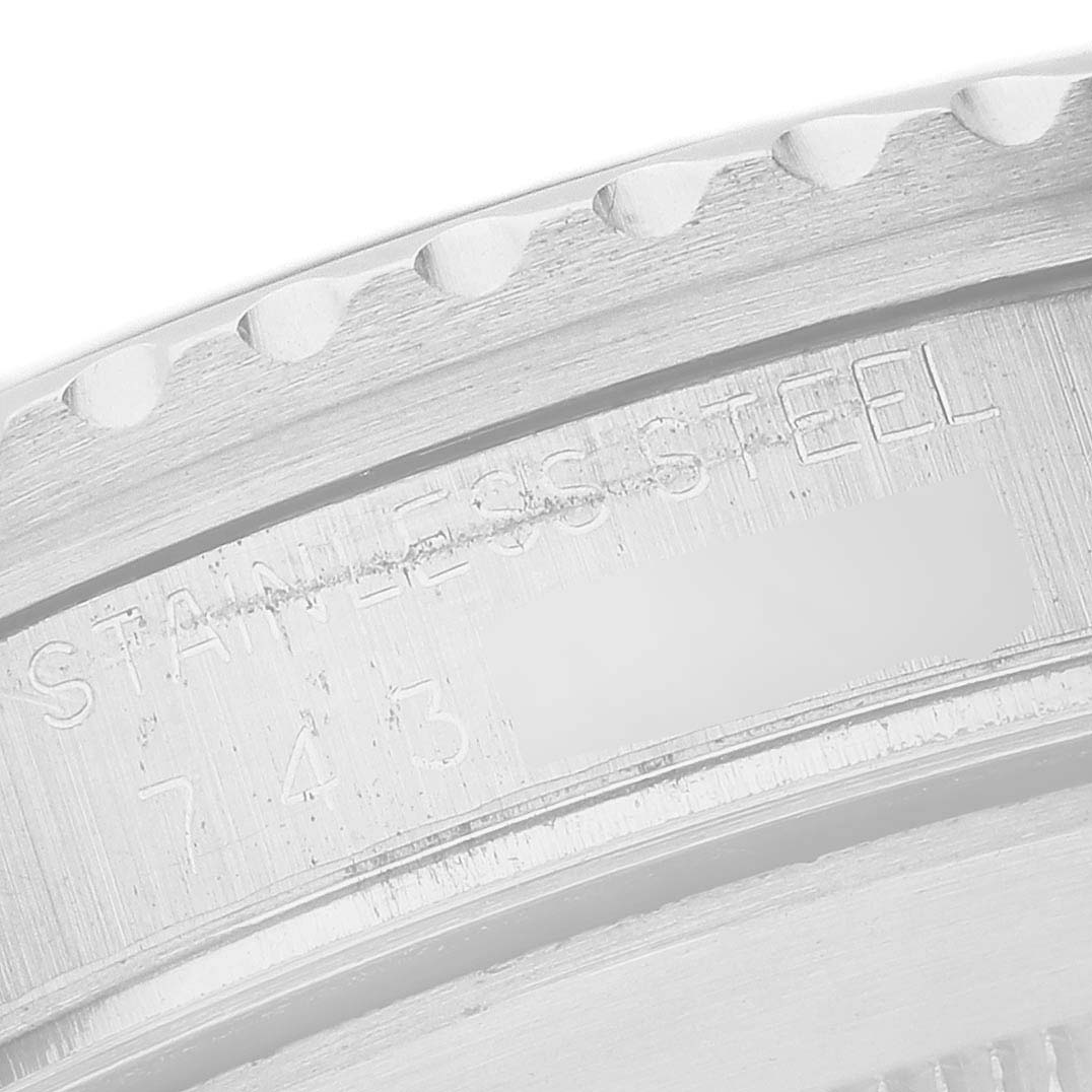 The image shows a close-up of the Rolex Submariner 16800 Men's Stainless Steel Black Dial's case side, focusing on the edge engraving and stainless steel text.