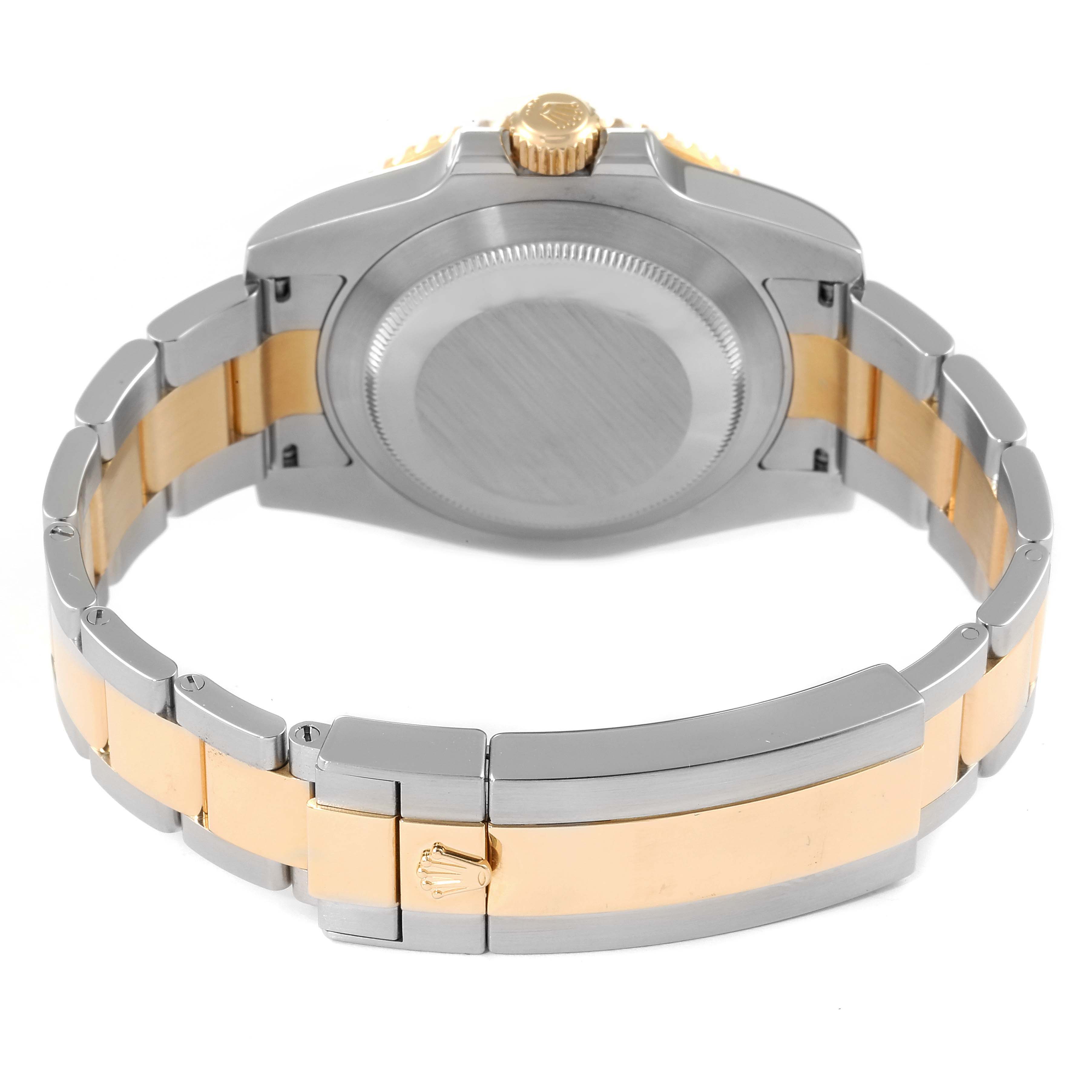 The image shows the back view of a Rolex Submariner 116613 Men
s Steel and Gold (two tone) Blue Dial 116613 Men
s Steel and Gold (two tone) Blue Dial watch, focusing on the watch case and the two-tone bracelet.