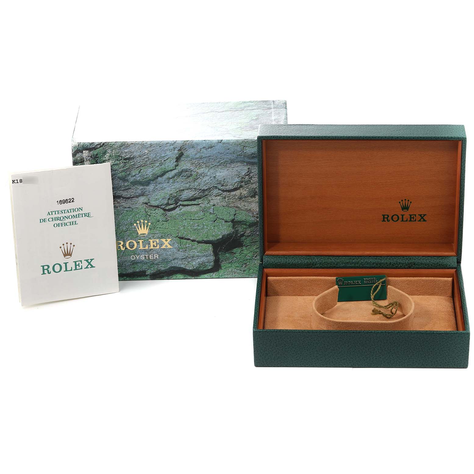 This image shows a Rolex Yacht-Master 169622 Women's Stainless Steel Silver Dial 169622 Women's Stainless Steel Silver Dial box set with a booklet and a green and gold tag inside the watch case.