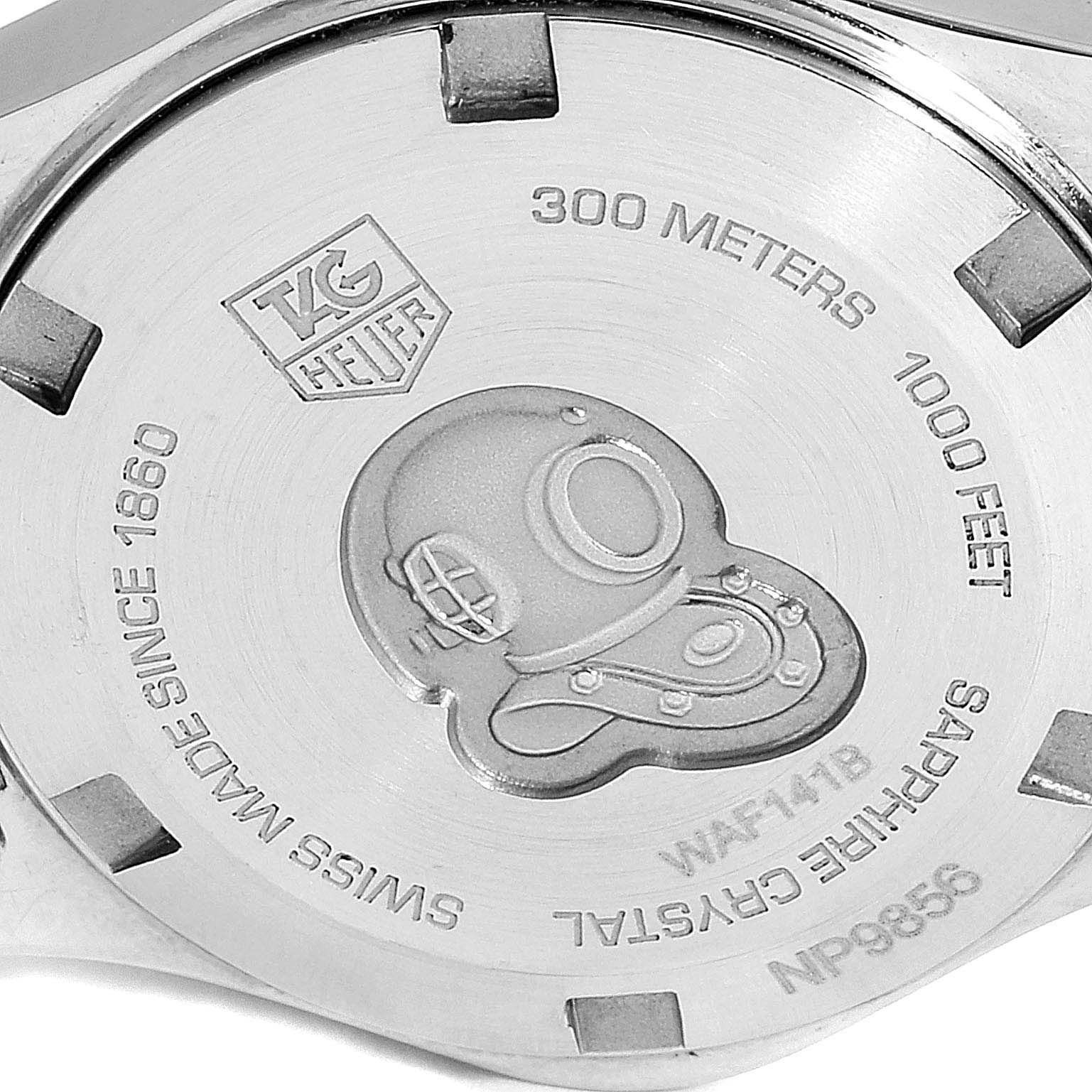 This image shows the back case of a Tag Heuer Aquaracer WAF141B.BA0824 Women's Stainless Steel Mother of Pearl Dial WAF141B.BA0824 Women's Stainless Steel Mother of Pearl Dial watch, featuring engravings and the brand logo.