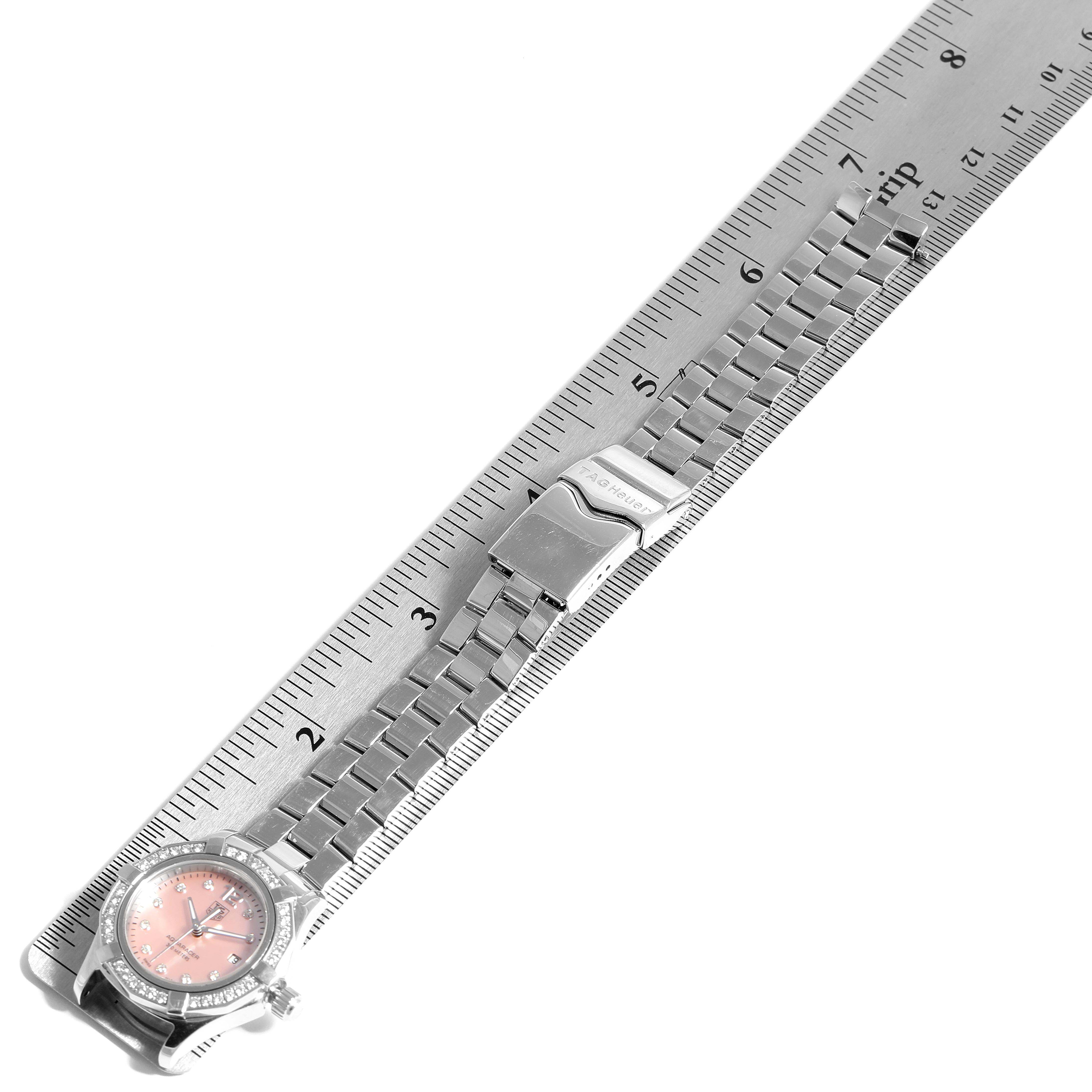 The image shows a Tag Heuer Aquaracer WAF141B.BA0824 Women's Stainless Steel Mother of Pearl Dial WAF141B.BA0824 Women's Stainless Steel Mother of Pearl Dial watch laid flat next to a ruler, displaying the watch case, dial, and bracelet.