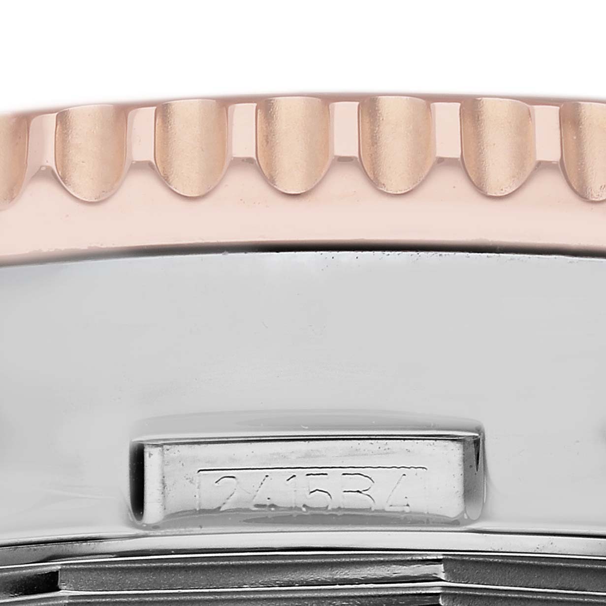 The image shows a close-up of the side of the Breitling Navitimer UB0127 Men
s Steel and Gold (two tone) Black Dial UB0127 Men
s Steel and Gold (two tone) Black Dial watch, highlighting the bezel
s edge and case with an engraved serial number.