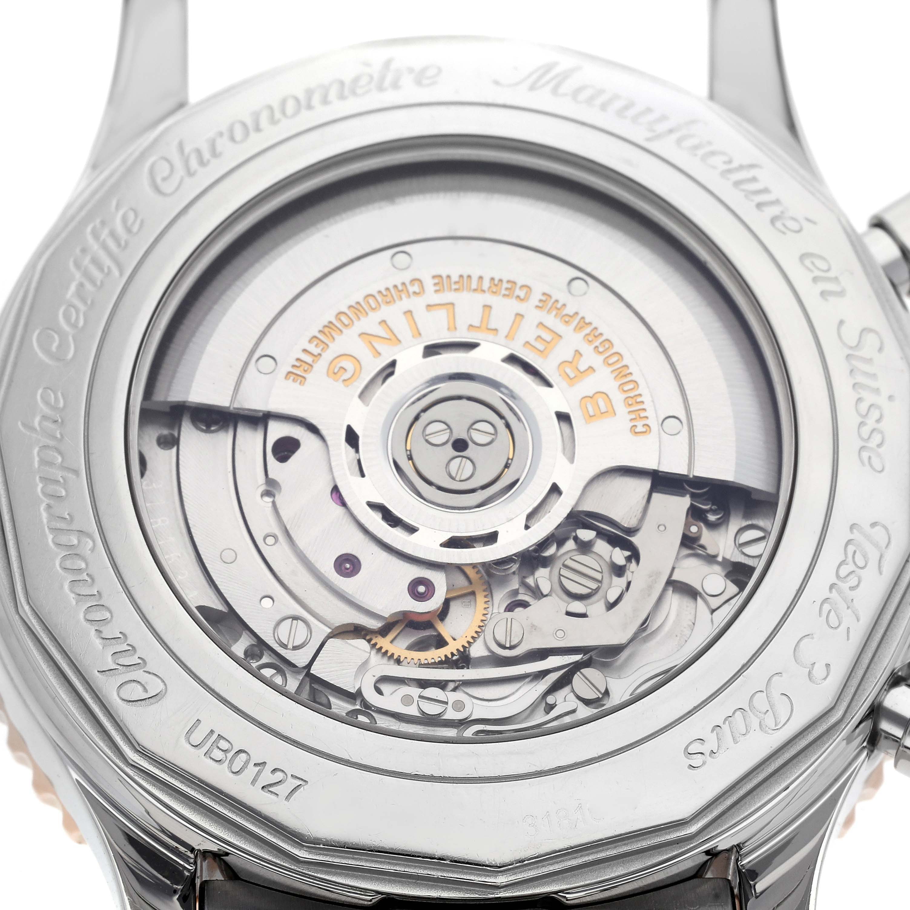 The image shows the back of a Breitling Navitimer UB0127 Men
s Steel and Gold (two tone) Black Dial UB0127 Men
s Steel and Gold (two tone) Black Dial watch, highlighting its exposed movement and rotor.